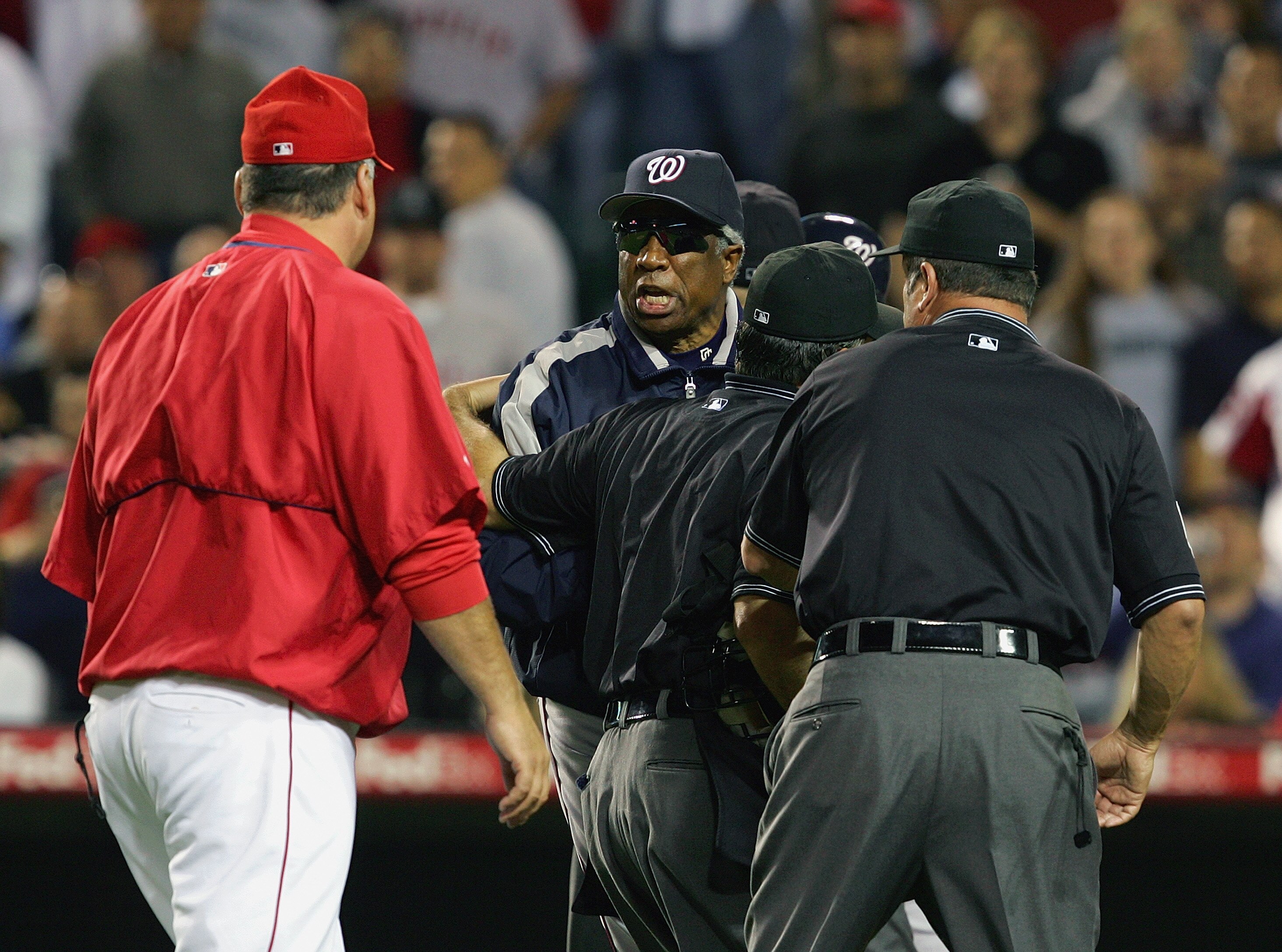 ANAHEIM, CA - JUNE 14:  Manager Mike Scioscia of the Los Angeles Angels of Anaheim exchanges words with manager Frank Robinson of the Washington Nationals during the Interleague game on June 14, 2005 at Angel Stadium in Anaheim, California.  The Nationals