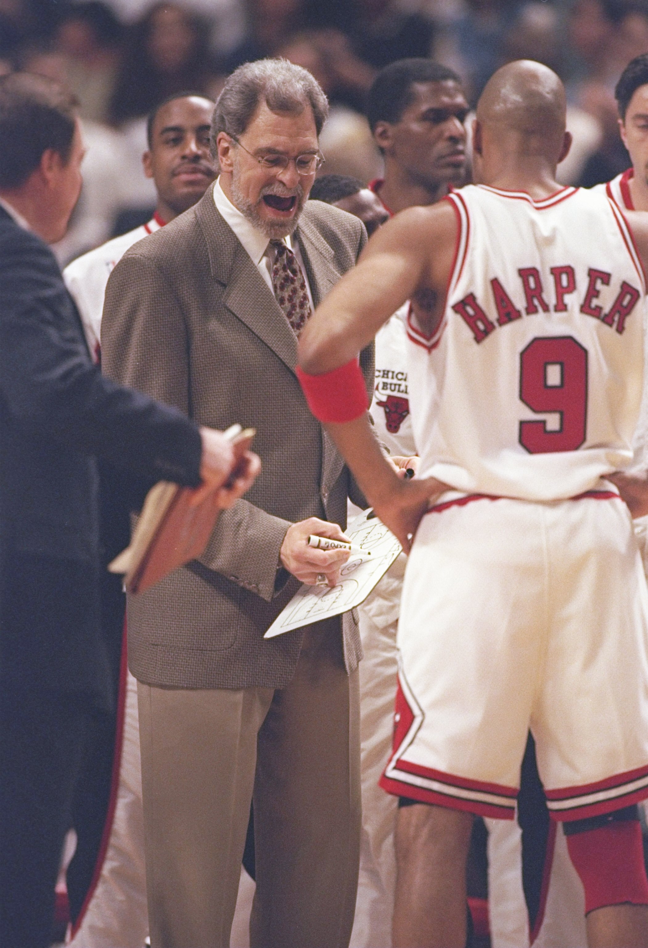 4 Jun 1997:  Coach Phil Jackson speaks with guards Ron Harper and Toni Kukoc of the Chicago Bulls during a playoff game against the Utah Jazz at the United Center in Chicago, Illinois.  The Bulls won the game 97-85. Mandatory Credit: Jonathan Daniel  /All