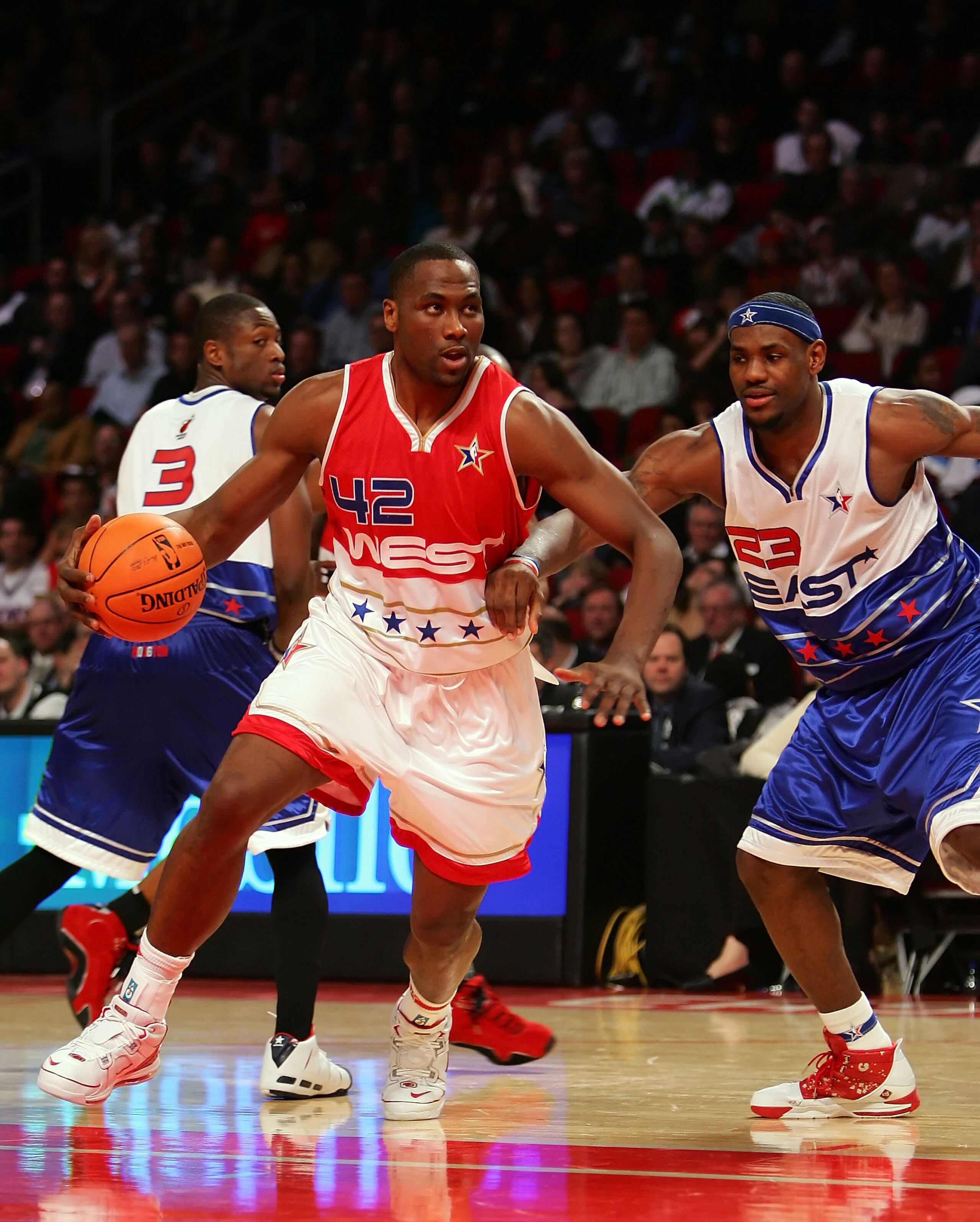 HOUSTON - FEBRUARY 18:  Elton Brand #42 of the West Team drives on LeBron James #23 of the East at the 2006 NBA All-Star Game during NBA All-Star Weekend at the Toyota Center on February 19, 2006 in Houston, Texas. The East defeated the West 122-120. NOTE