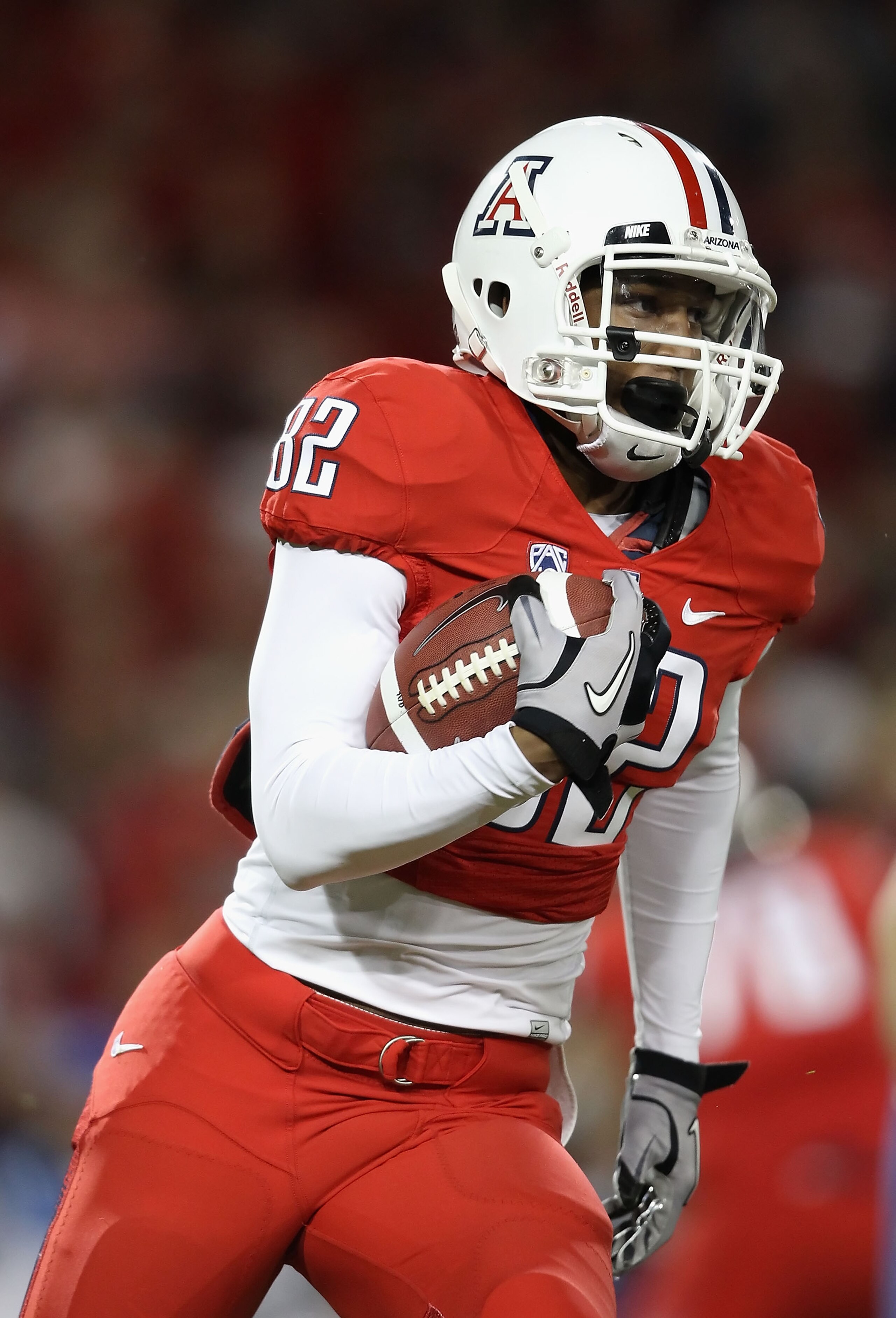 TUCSON, AZ - OCTOBER 23:  Wide receiver Juron Criner #82 of the Arizona Wildcats runs with the ball during the college football game against the Washington Huskies at Arizona Stadium on October 23, 2010 in Tucson, Arizona.   The Wildcats defeated the Husk