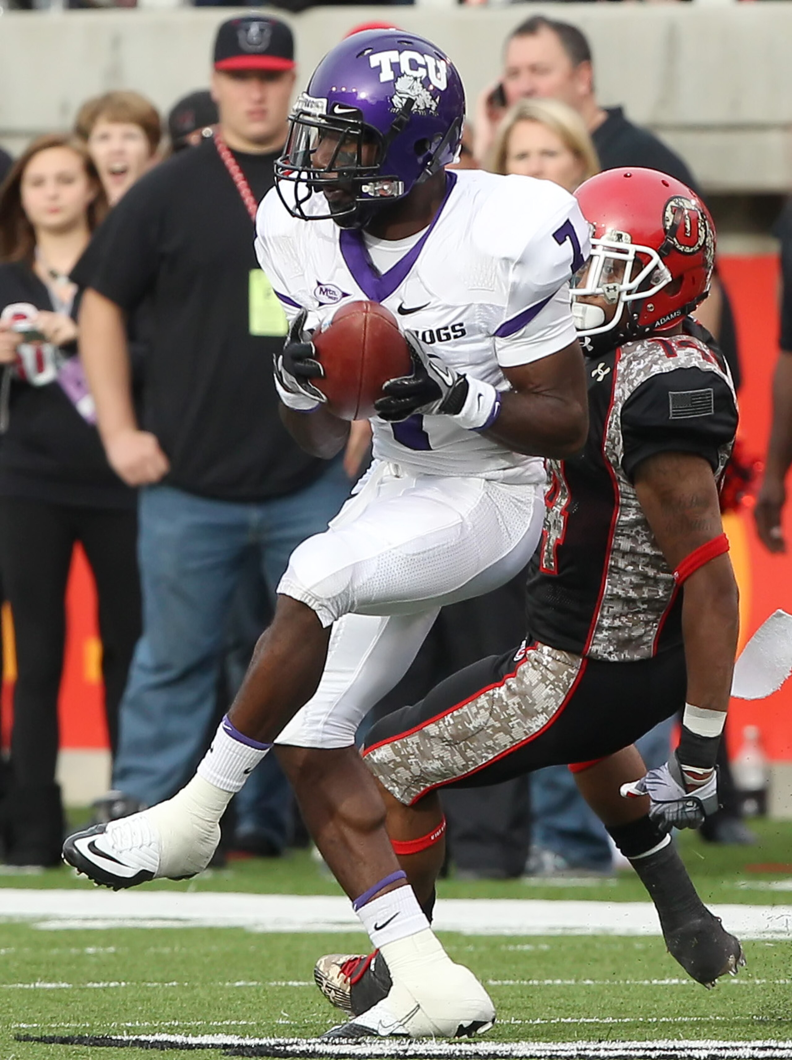 SALT LAKE CITY, UT - NOVEMBER 6: Greg McCoy #7 of the TCU Horned Frogs intercepts the ball from Reggie Dunn #14 the Utah Utes during the second half of an NCAA Football game November 6, 2010 at Rice-Eccles Stadium in Salt Lake City, Utah. TCU Beat Utah 47 SALT LAKE CITY, UT - NOVEMBER 6: Greg McCoy #7 of the TCU Horned Frogs intercepts the ball from Reggie Dunn #14 the Utah Utes during the second half of an NCAA Football game November 6, 2010 at Rice-Eccles Stadium in Salt Lake City, Utah. TCU Beat Utah 47