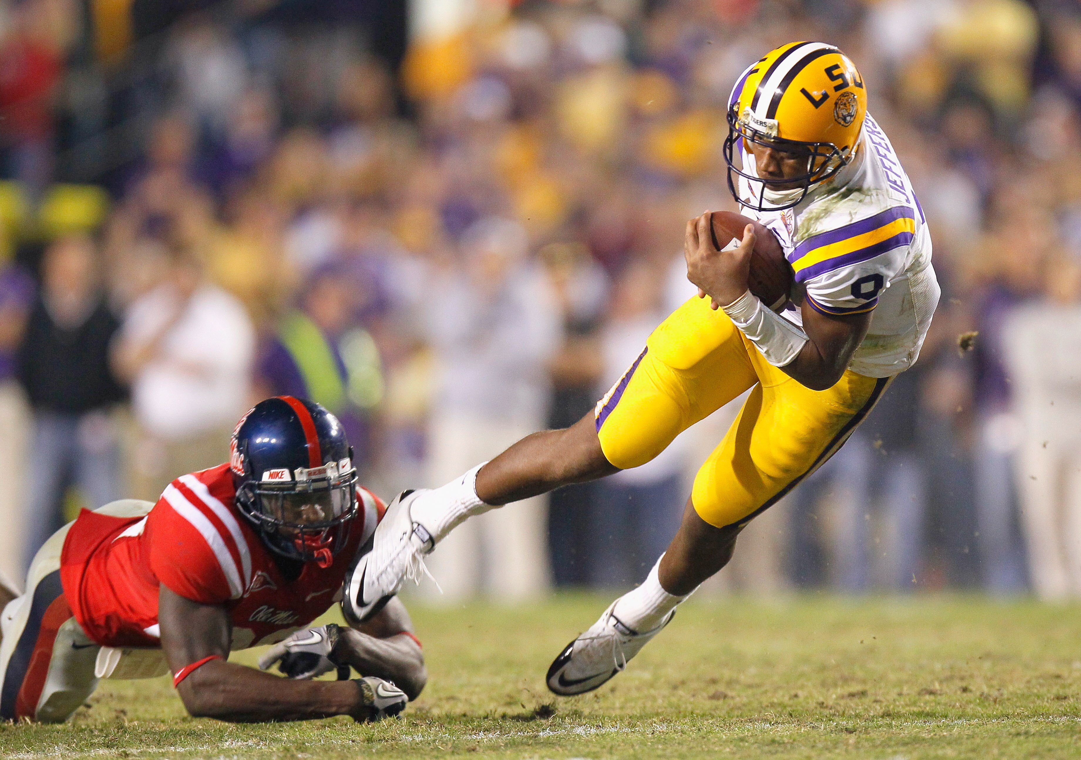 BATON ROUGE, LA - NOVEMBER 20:  Quarterback Jordan Jefferson #9 of the Louisiana State University Tigers is tripped up by Johnny Brown #20 of the Ole Miss Rebels at Tiger Stadium on November 20, 2010 in Baton Rouge, Louisiana.  (Photo by Kevin C. Cox/Gett