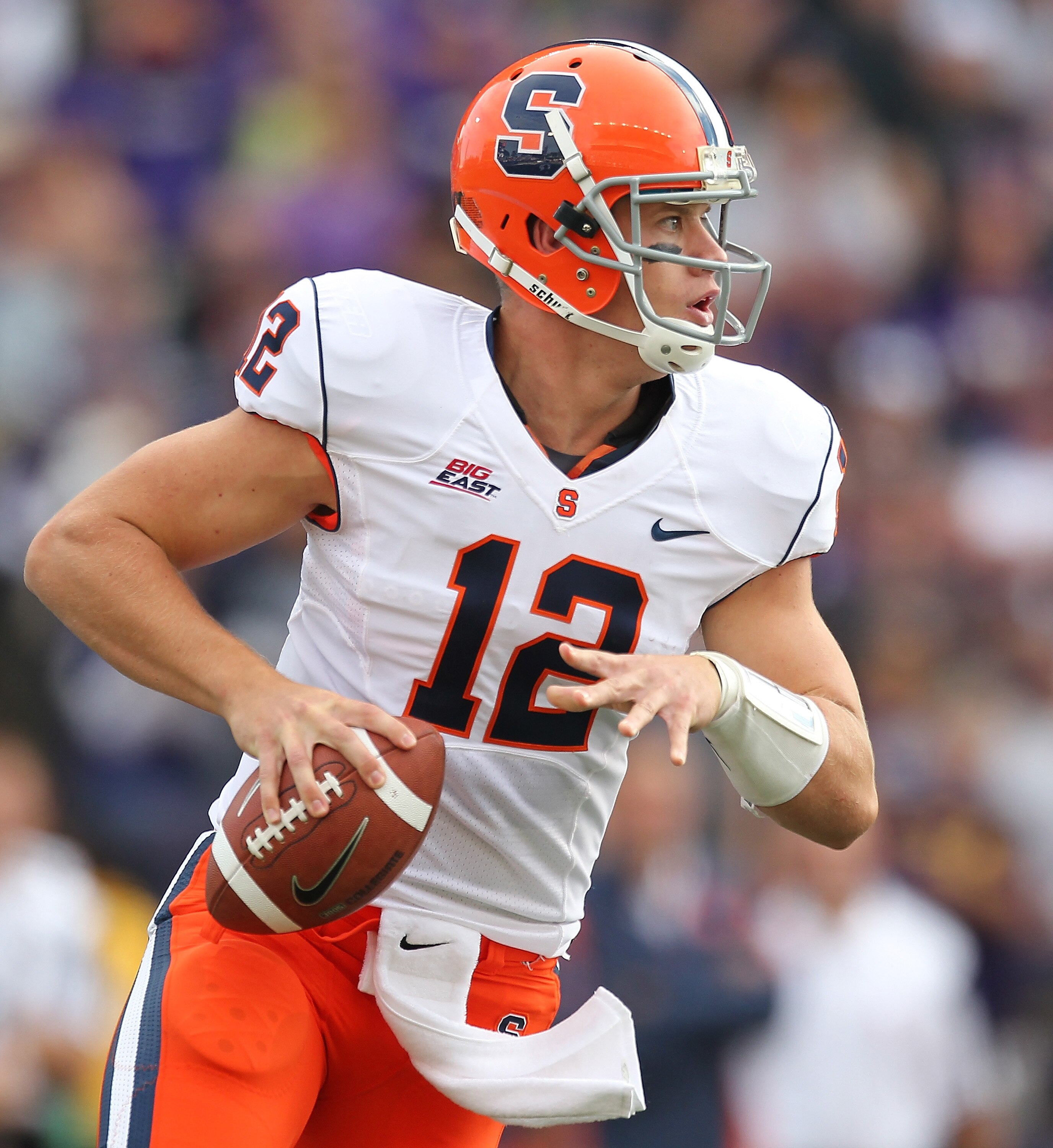 SEATTLE - SEPTEMBER 11:  Quarterback Ryan Nassib #12 of the Syracuse Orange rolls out to pass against the Washington Huskies on September 11, 2010 at Husky Stadium in Seattle, Washington. The Huskies defeated the Orange 41-20. (Photo by Otto Greule Jr/Get