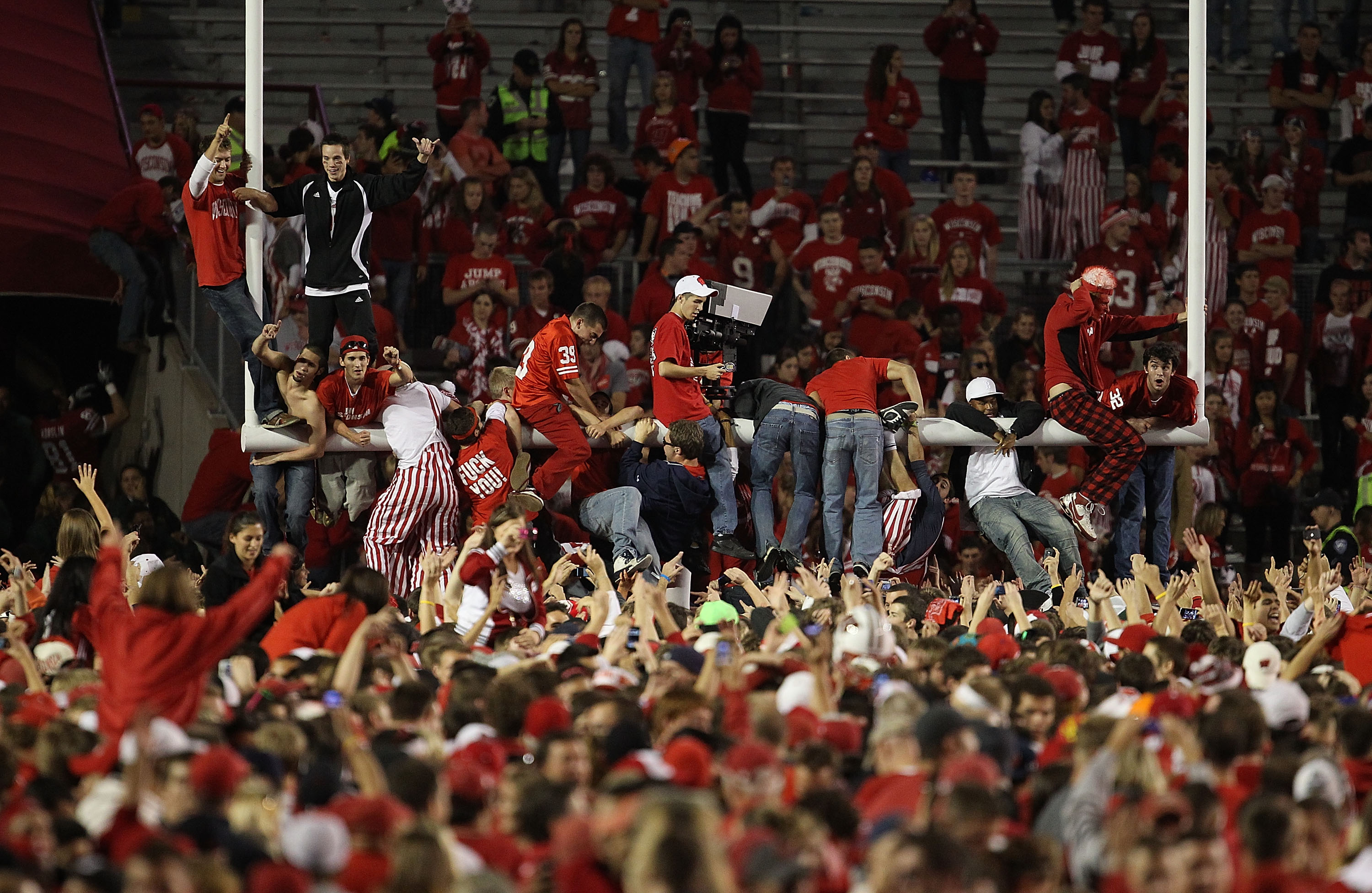 MADISON, WI - OCTOBER 16: Fans of the Wisconsin Badgers celebrate on the field following a win against the Ohio State Buckeyes at Camp Randall Stadium on October 16, 2010 in Madison, Wisconsin. Wisconsin defeated Ohio State 31-18. (Photo by Jonathan Danie