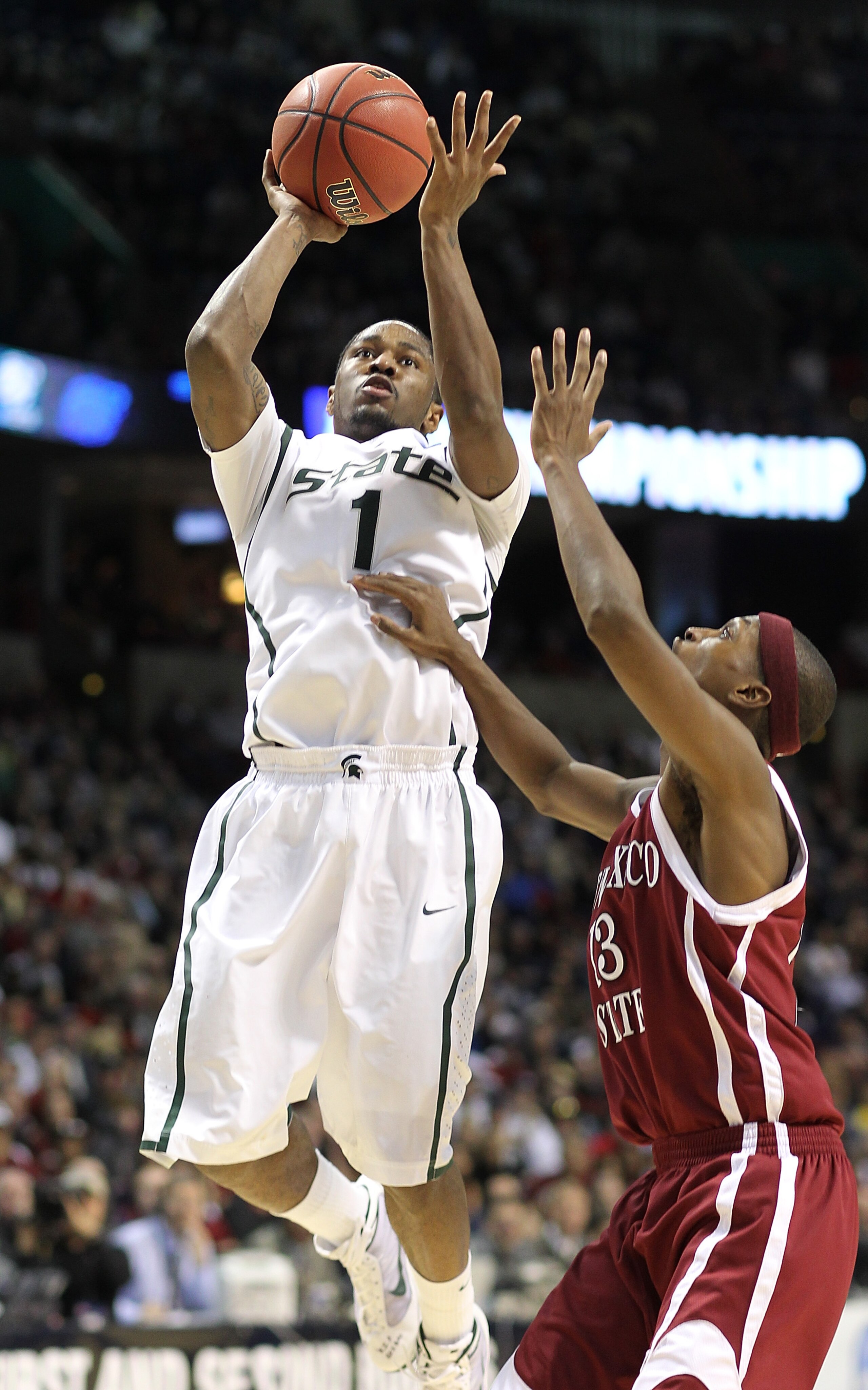 SPOKANE - MARCH 19:  Kalin Lucas #1 of the Michigan State Spartans shoots against Hernst Laroche #13 of the New Mexico State Aggies during the first round of the 2010 NCAA men's basketball tournament at the Spokane Arena on March 19, 2010 in Spokane, Wash