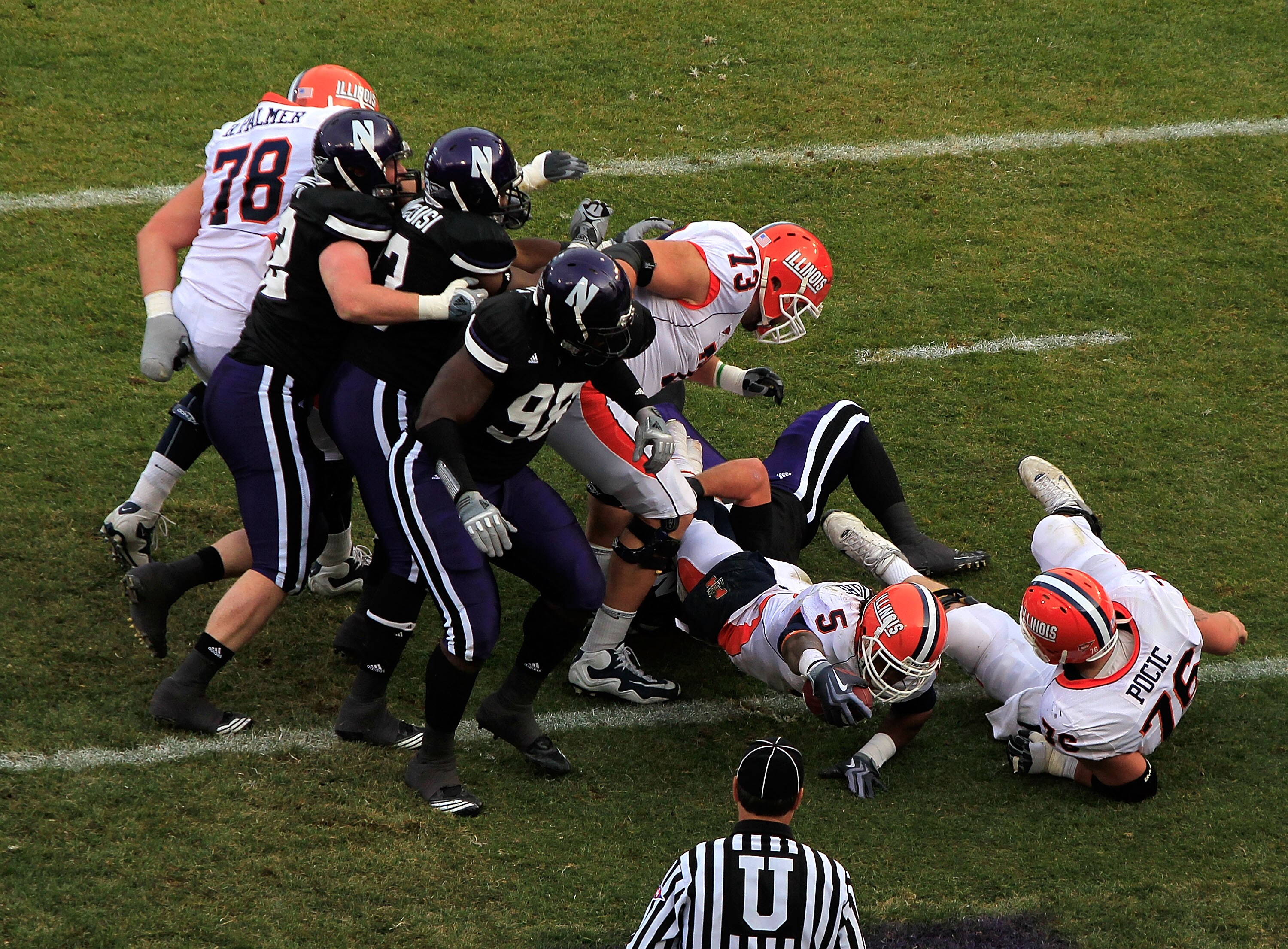 CHICAGO - NOVEMBER 20: Mikel Leshoure #5 of the Illinois Fighting Illini follows blocker Graham Pocic #76 into the end zone for a touchdown against the Northwestern Wildcats during a game played at Wrigley Field on November 20, 2010 in Chicago, Illinois.