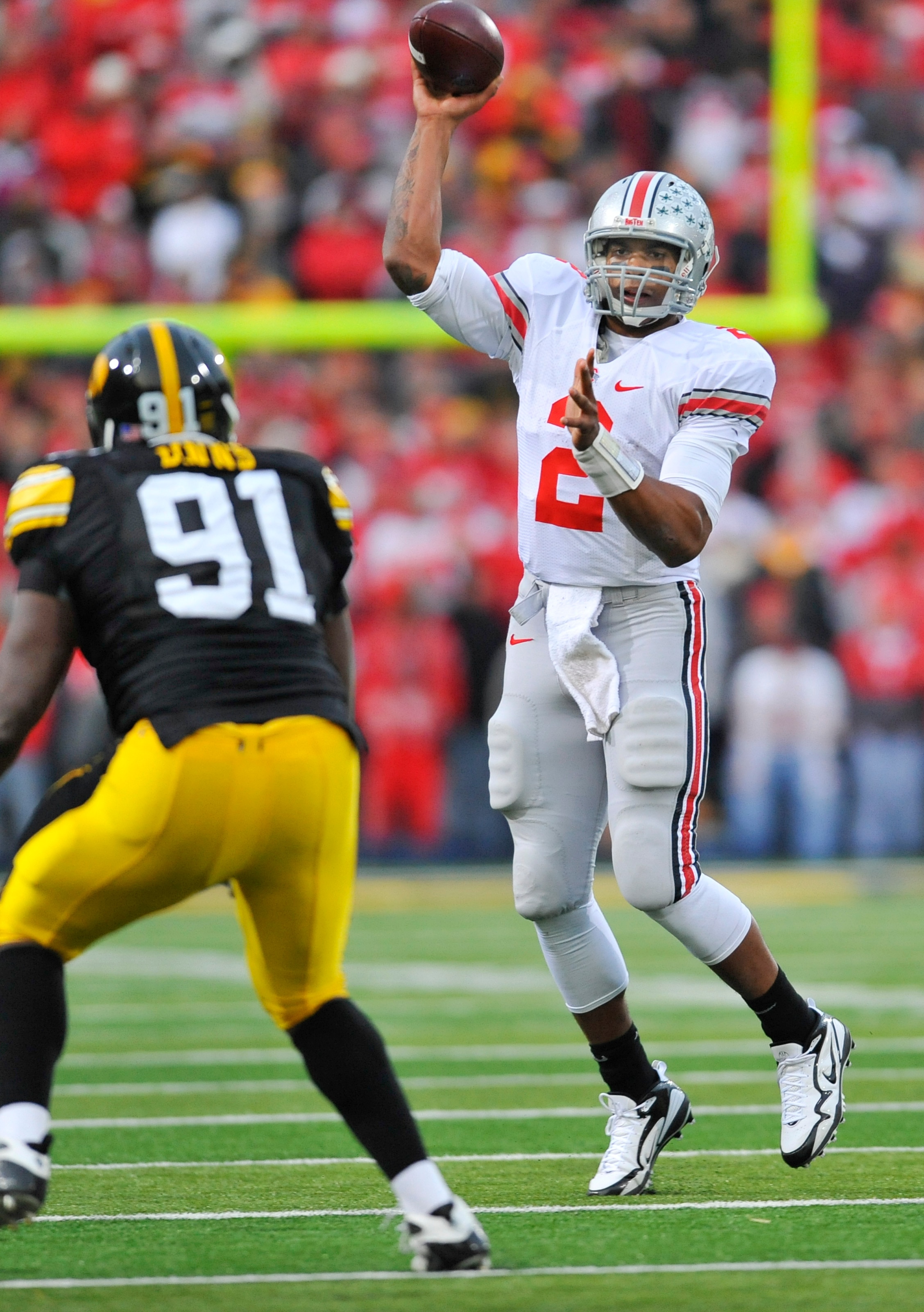 IOWA CITY, IA - NOVEMBER 20: Quarterback Terrelle Pryor #2 of the Ohio State Buckeyes throws under pressure from defensive lineman Broderick Binns #91 of the University of Iowa Hawkeyes during the second half of play at Kinnick Stadium on November 20, 201