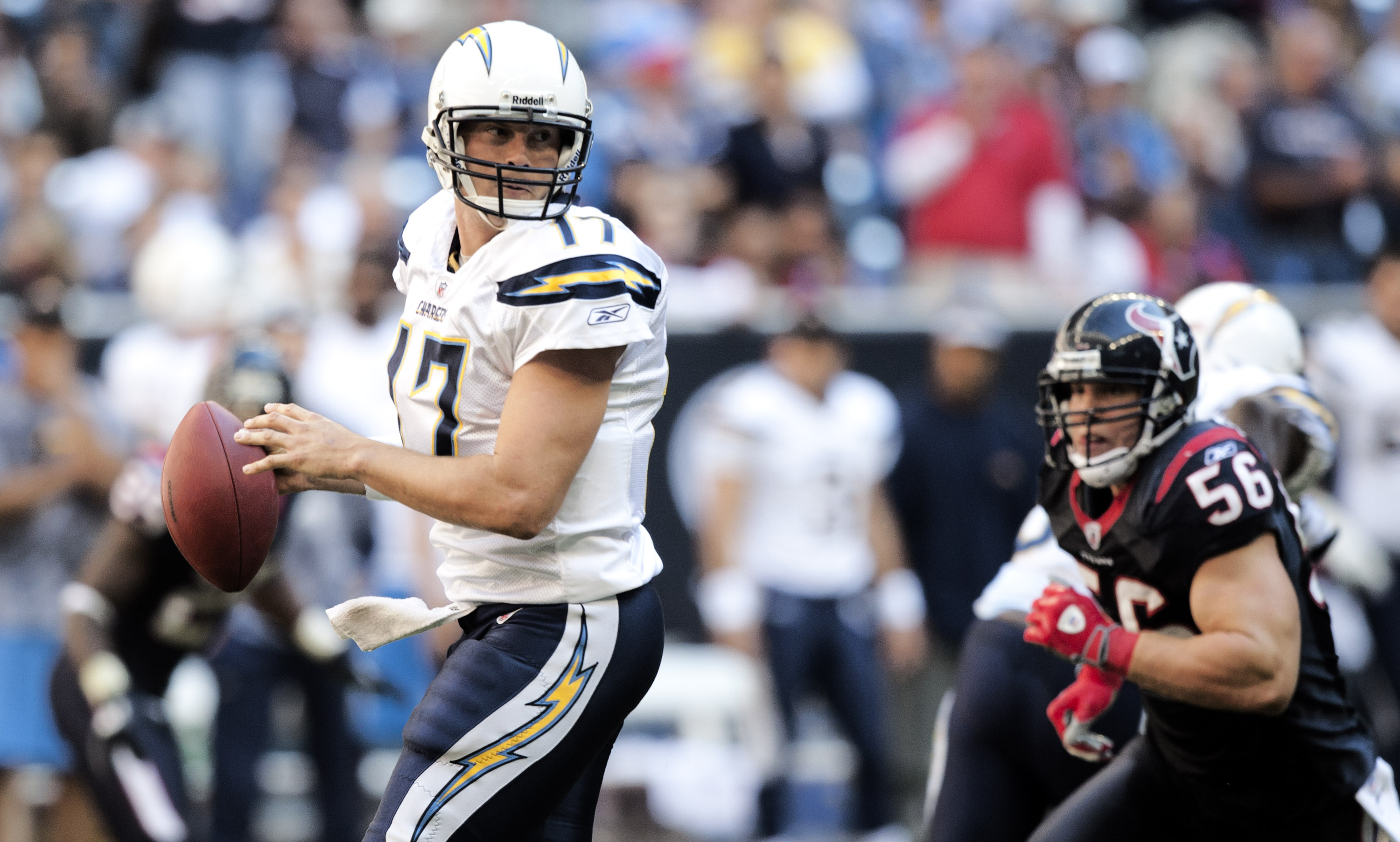 HOUSTON - NOVEMBER 07:  Quarterback Philip Rivers #17 of the San Diego Chargers looks for a receiver as linebacker Brian Cushing #56 of the Houston Texans applies pressure at Reliant Stadium on November 7, 2010 in Houston, Texas.  (Photo by Bob Levey/Gett