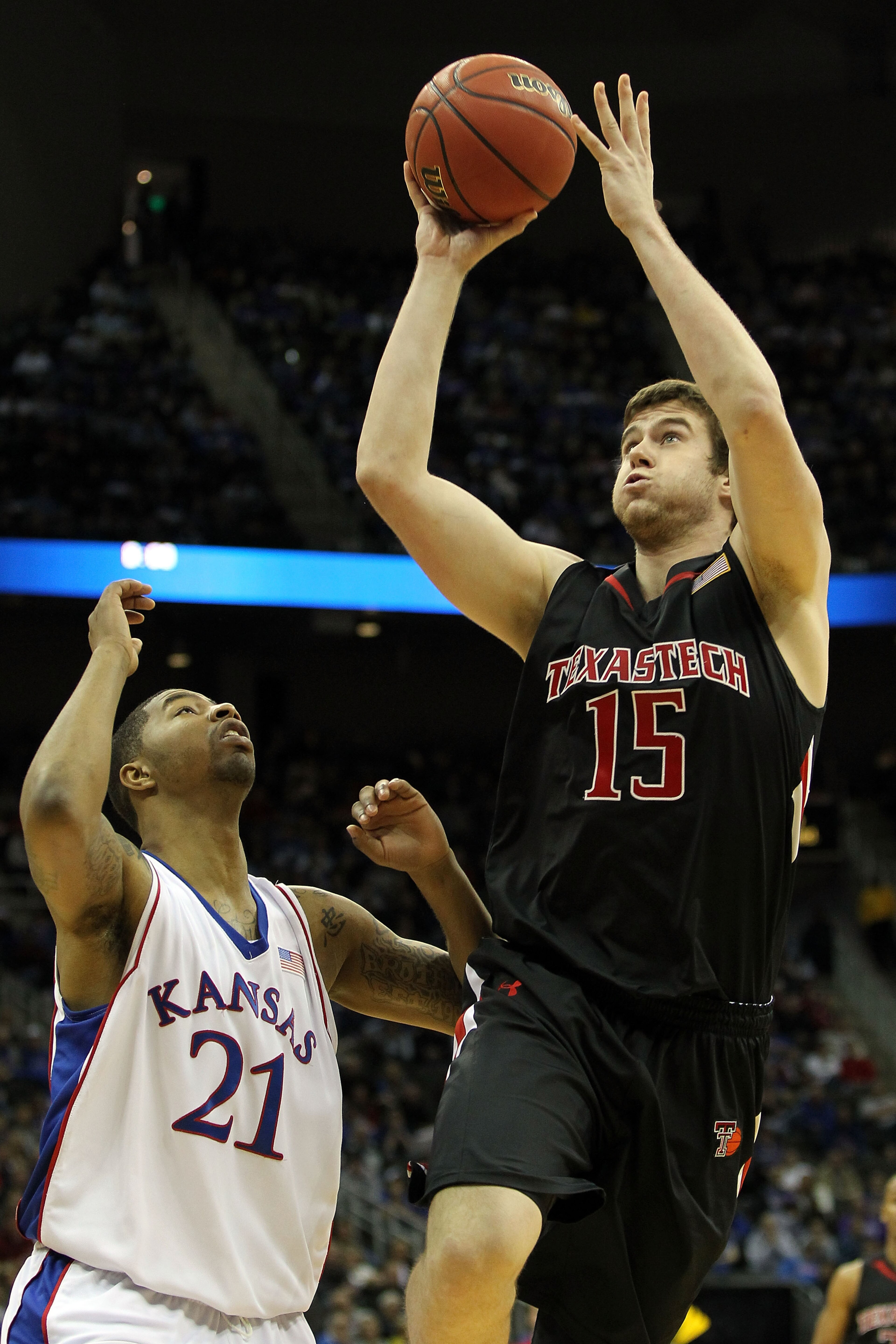 KANSAS CITY, MO - MARCH 11:  Robert Lewandowski #15 of the Texas Tech Red Raiders goes up for a shot over Markieff Morris #21 of the Kansas Jayhawks in the first half during the quarterfinals of the 2010 Phillips 66 Big 12 Men's Basketball Tournament at t