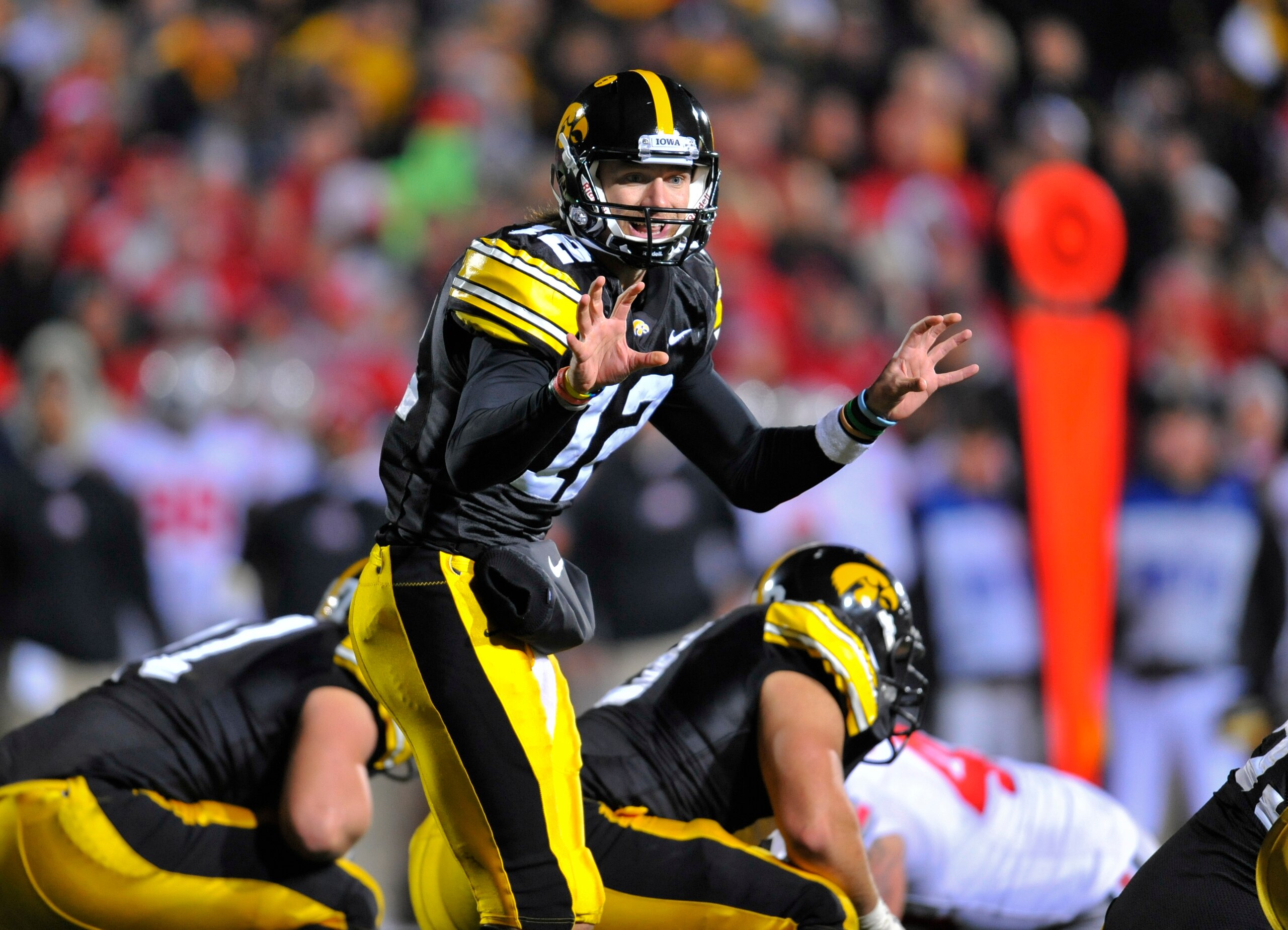 IOWA CITY, IA - NOVEMBER 20:  Quarterback Ricky Stanzi #12 of the University of Iowa Hawkeyes signals a call at the line during second half action against the Ohio State Buckeyes at Kinnick Stadium on November 20, 2010 in Iowa City, Iowa. Ohio State won 2