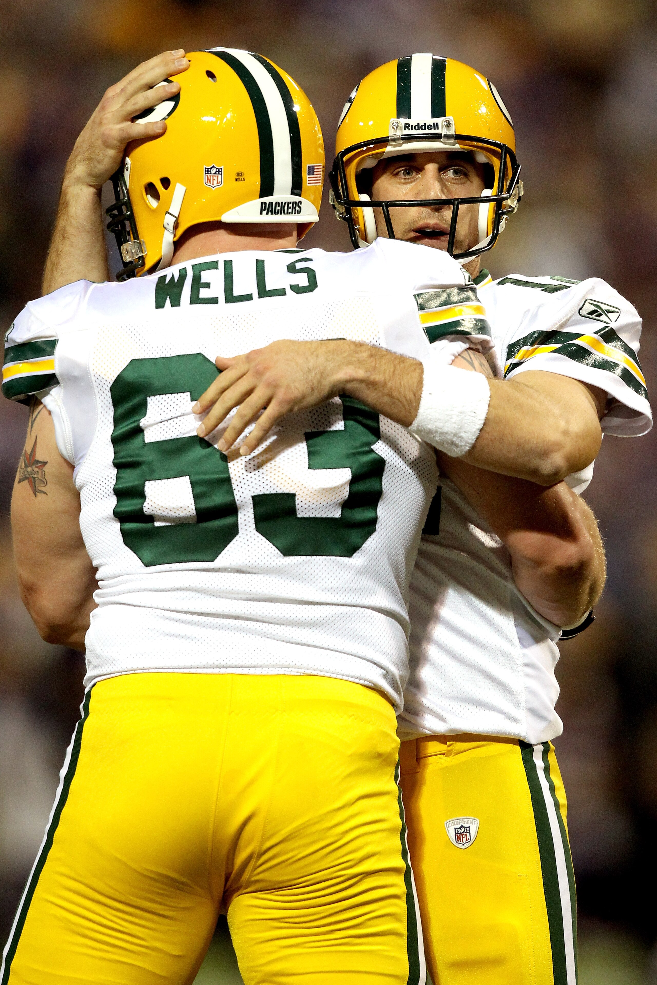MINNEAPOLIS - NOVEMBER 21:  Quarterback Aaron Rodgers #12 of the Green Bay Packers celebrates with Scott Wells #63 after throwing a touchdown against the Minnesota Vikings at the Hubert H. Humphrey Metrodome on November 21, 2010 in Minneapolis, Minnesota.