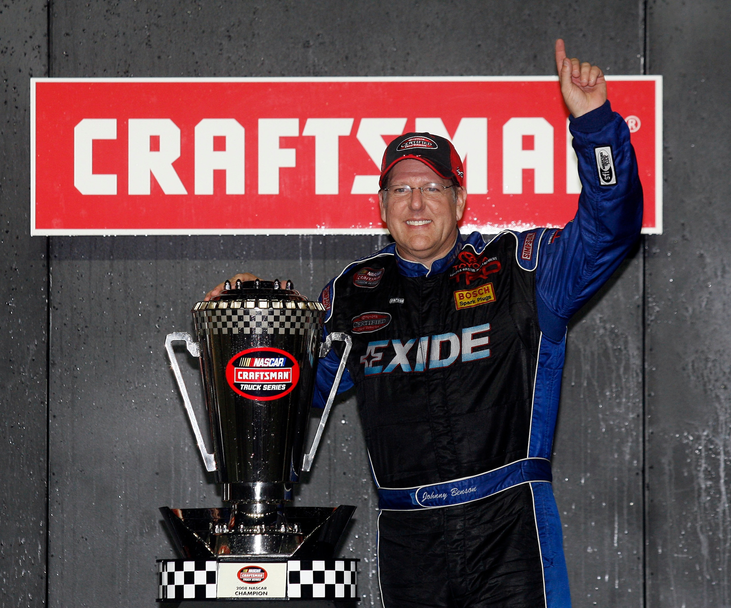 HOMESTEAD, FL - NOVEMBER 14:  Johnny Benson, driver of the #23 Exide Toyota, celebrates after winning the 2008 NASCAR Craftsman Truck Series Championship after racing during NASCAR Craftsman Truck Series Ford 200 at Homestead-Miami Speedway on November 14