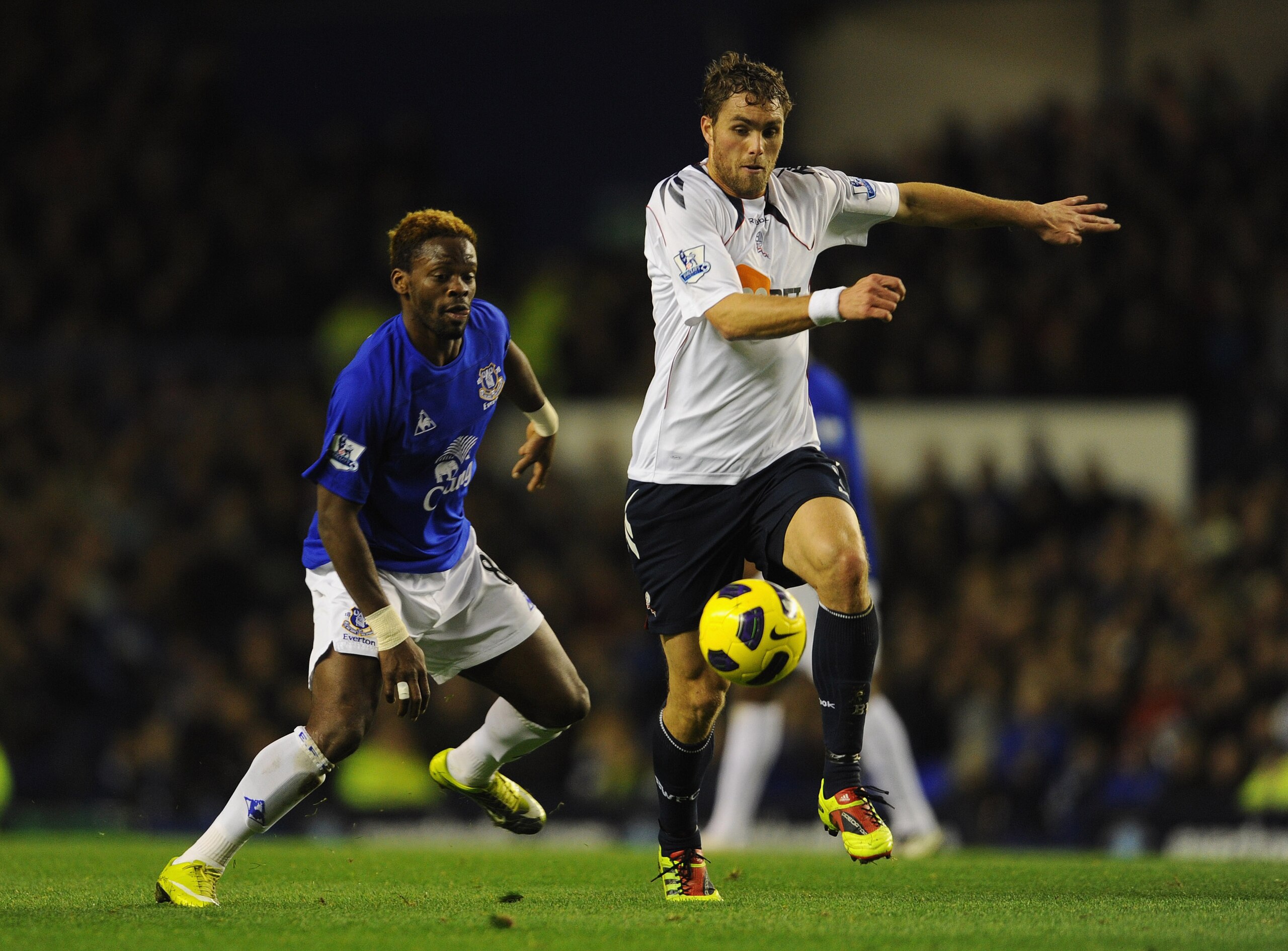 LIVERPOOL, ENGLAND - NOVEMBER 10:  Louis Saha of Everton is challenged by Johan Elmander of Bolton during the Barclays Premier League match between Everton and Bolton Wanderers at Goodison Park on November 10, 2010 in Liverpool, England.  (Photo by Michae