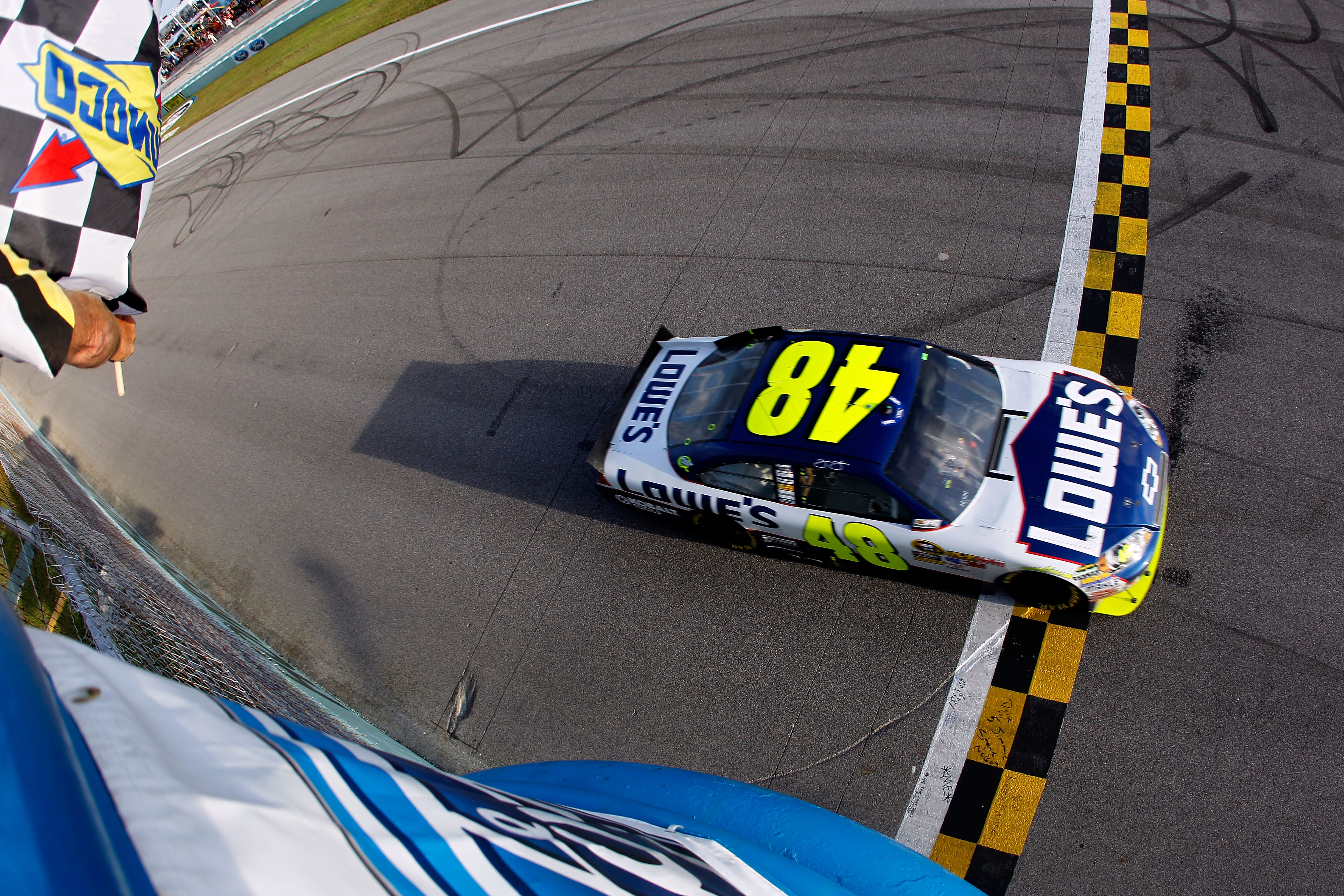 HOMESTEAD, FL - NOVEMBER 21:  Jimmie Johnson, driver of the #48 Lowe's Chevrolet, crosses the finish line in second place in the Ford 400 to clinch his fifth consecutive NASCAR Sprint Cup championship at Homestead-Miami Speedway on November 21, 2010 in Ho