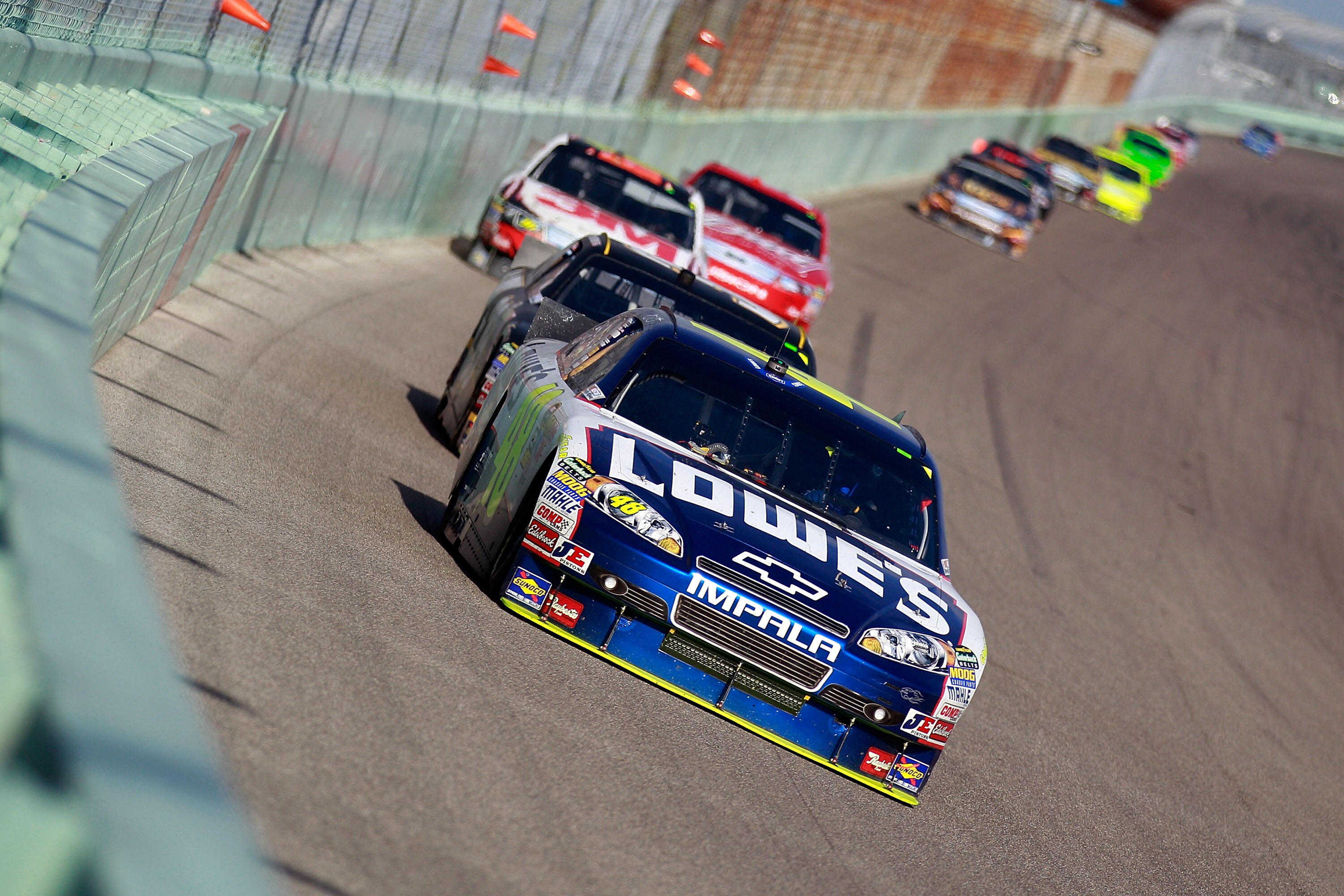 HOMESTEAD, FL - NOVEMBER 21:  Jimmie Johnson, driver of the #48 Lowe's Chevrolet, leads a line of cars during the NASCAR Sprint Cup Series Ford 400 at Homestead-Miami Speedway on November 21, 2010 in Homestead, Florida.  (Photo by Chris Graythen/Getty Ima