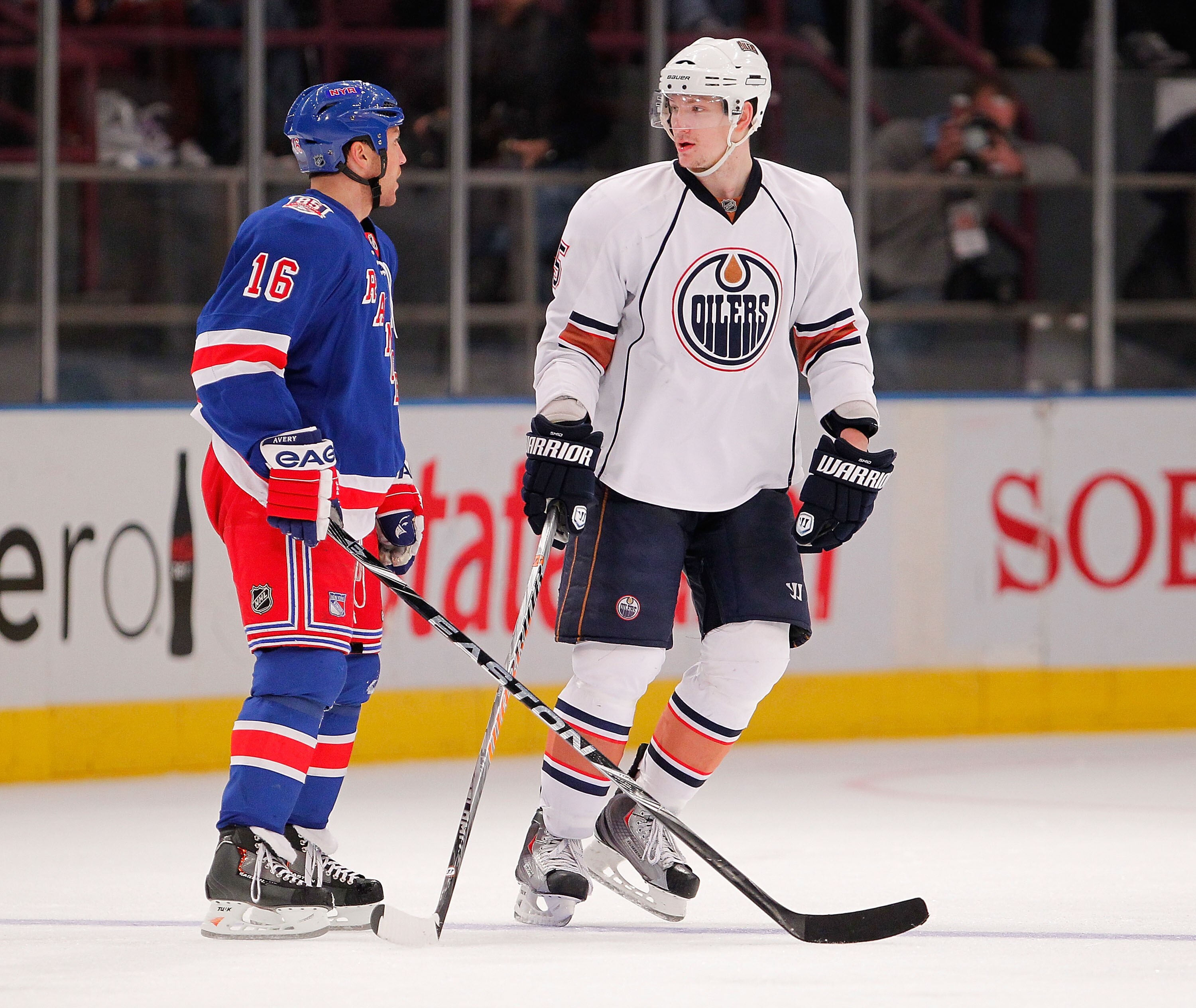 NEW YORK - NOVEMBER 14:  Ladislav Smid #5 of the Edmonton Oilers talks with Sean Avery #16 of the New York Rangers moments before Avery started fighting him in the third period of a hockey game at Madison Square Garden on November 14, 2010 in New York Cit