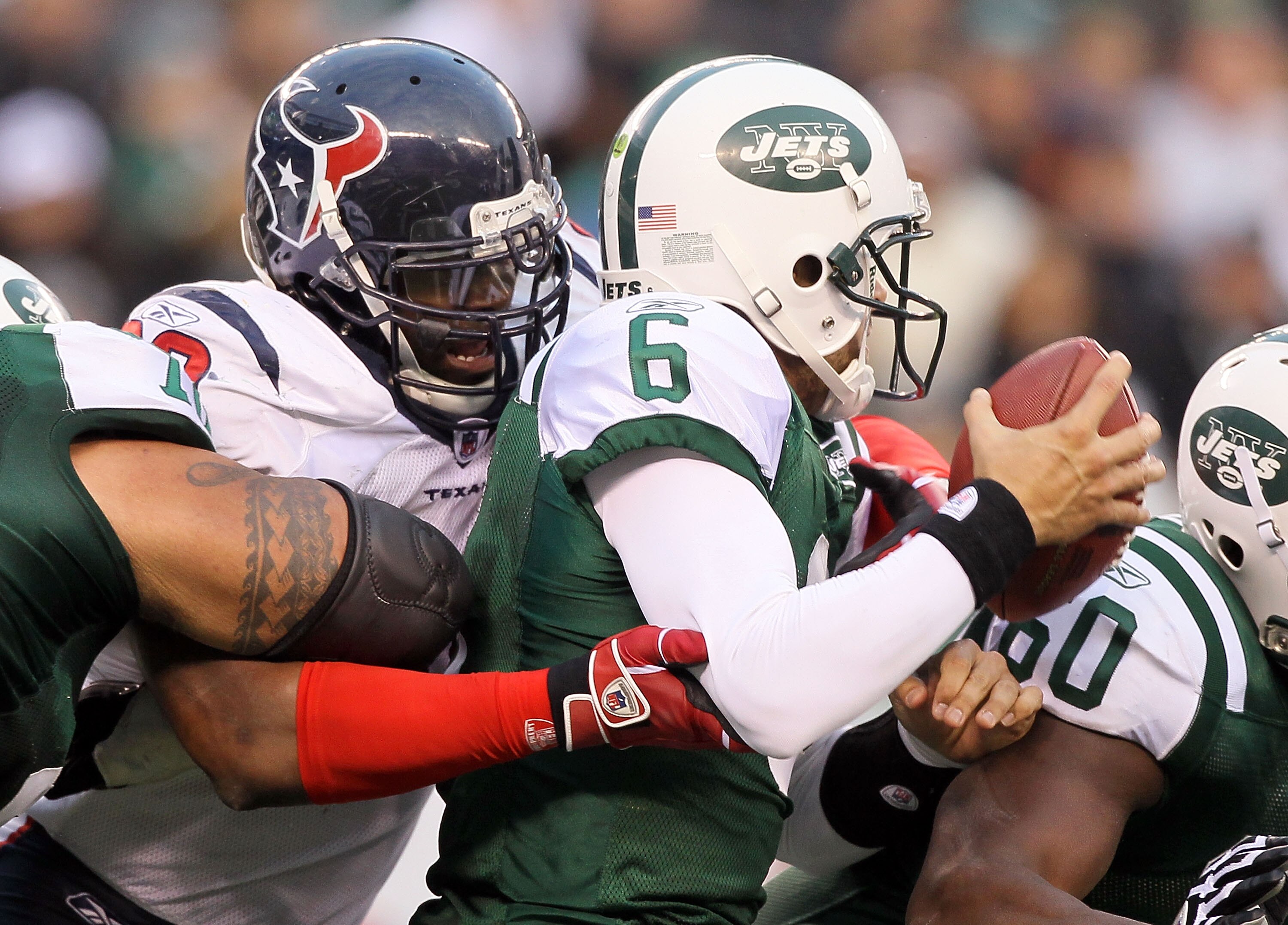 EAST RUTHERFORD, NJ - NOVEMBER 21: Mark Sanchez #6 of the New York Jets is sacked by Mario Williams #90 of the Houston Texans on November 21, 2010 at the New Meadowlands Stadium in East Rutherford, New Jersey. The Jets defeated the Texans 30-27.  (Photo b