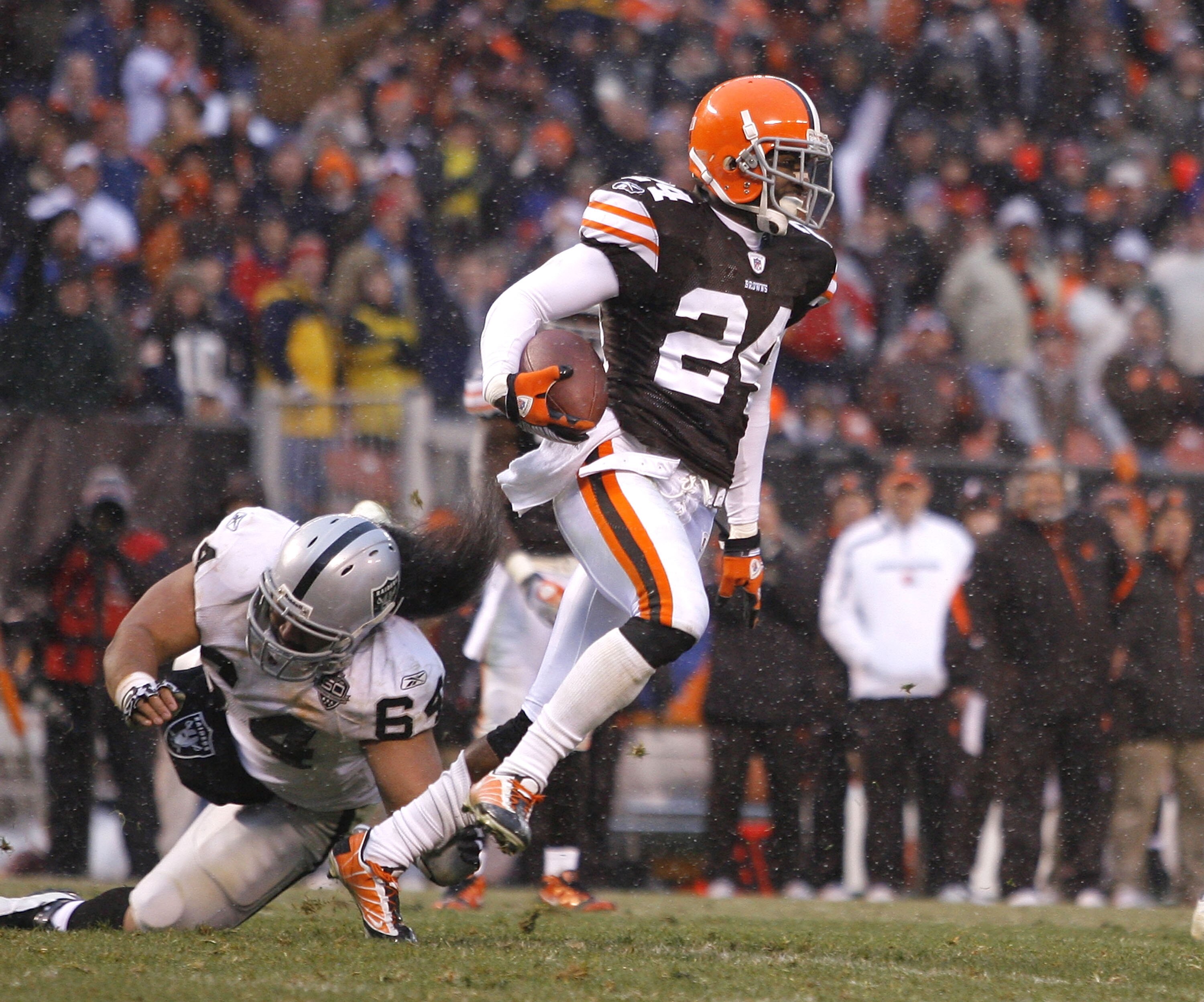 CLEVELAND - DECEMBER 27:  Eric Wright #24 of the Cleveland Browns returns an interception past Samson Satele #64 of the Oakland Raiders at Cleveland Browns Stadium on December 27, 2009 in Cleveland, Ohio.  (Photo by Matt Sullivan/Getty Images)