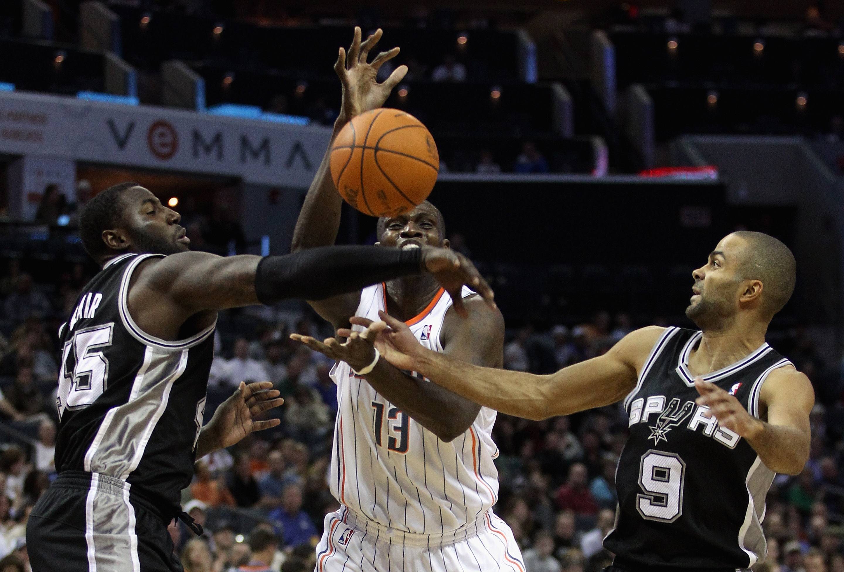 CHARLOTTE, NC - NOVEMBER 08:  Teammates Tony Parker #9 and DeJuan Blair #45 of the San Antonio Spurs battle for a loose ball with Nazr Mohammed #13 of the Charlotte Bobcats during their game at Time Warner Cable Arena on November 8, 2010 in Charlotte, Nor