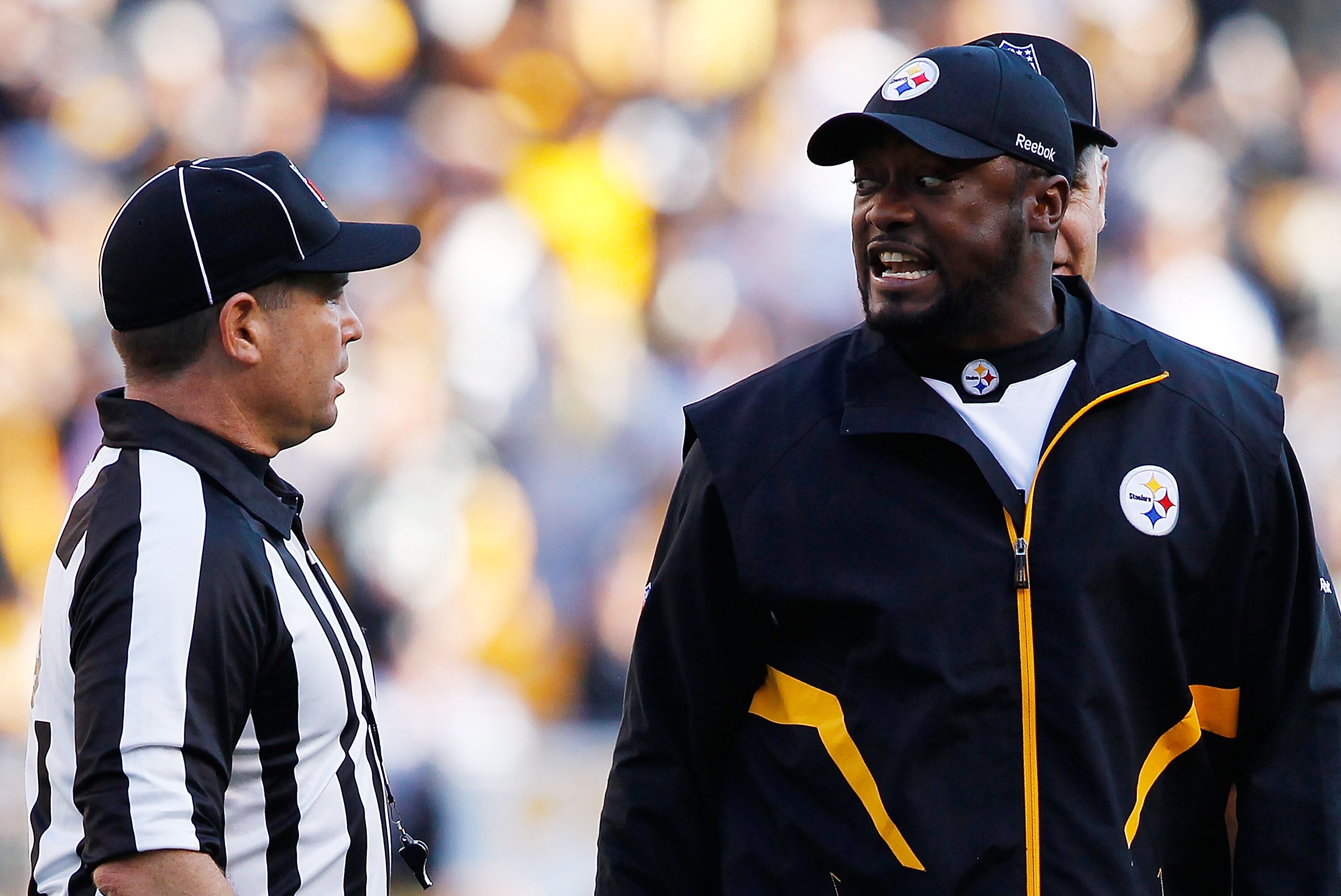 PITTSBURGH - NOVEMBER 21:  Head coach Mike Tomlin of the Pittsburgh Steelers argues with referees after a scrum took place in the middle of the field during the game against the Oakland Raiders on November 21, 2010 at Heinz Field in Pittsburgh, Pennsylvan