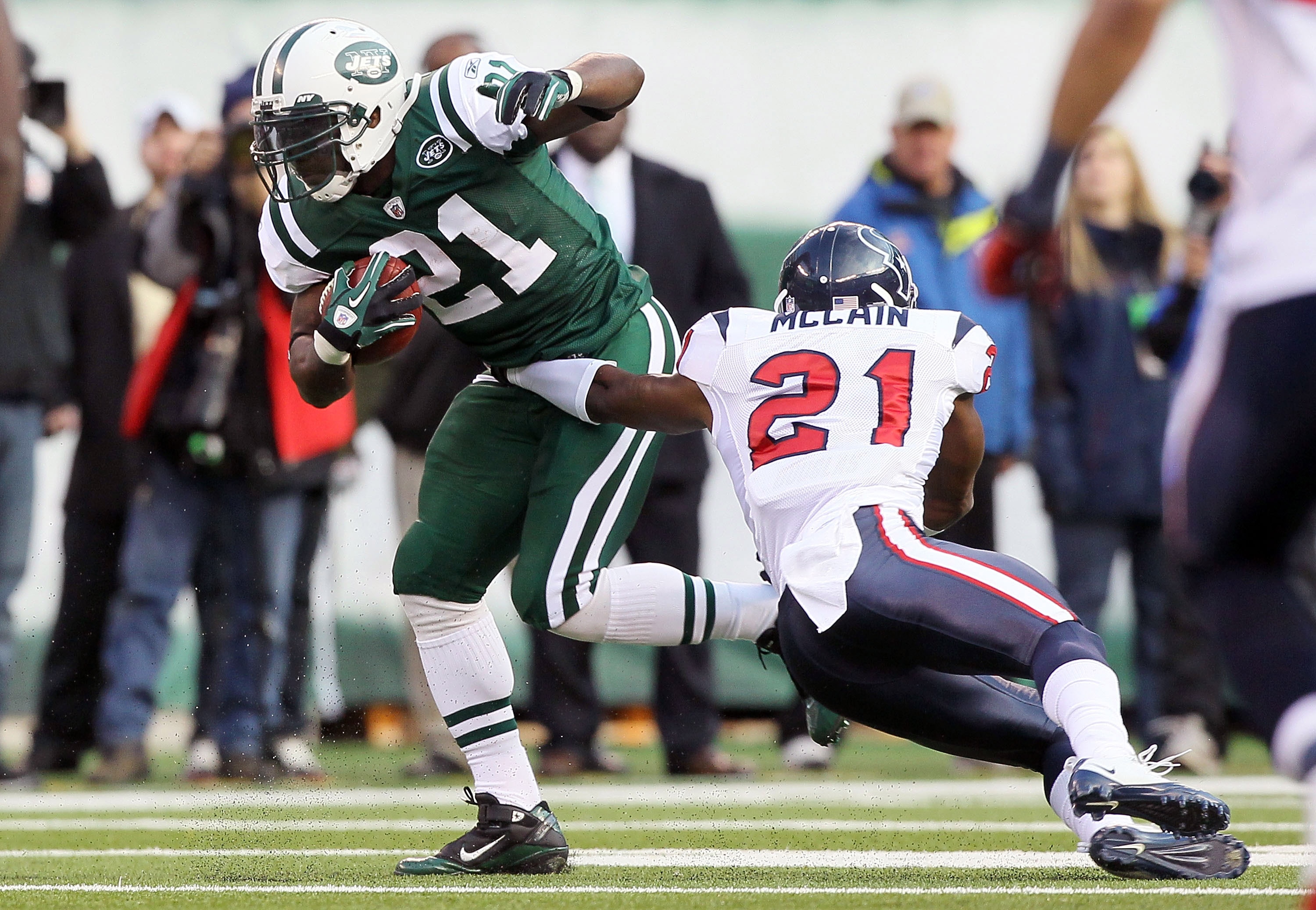 EAST RUTHERFORD, NJ - NOVEMBER 21:  LaDainian Tomlinson #21 of the New York Jets runs the ball past Brice McCain #21 of the Houston Texans on November 21, 2010 at the New Meadowlands Stadium in East Rutherford, New Jersey.  (Photo by Jim McIsaac/Getty Ima