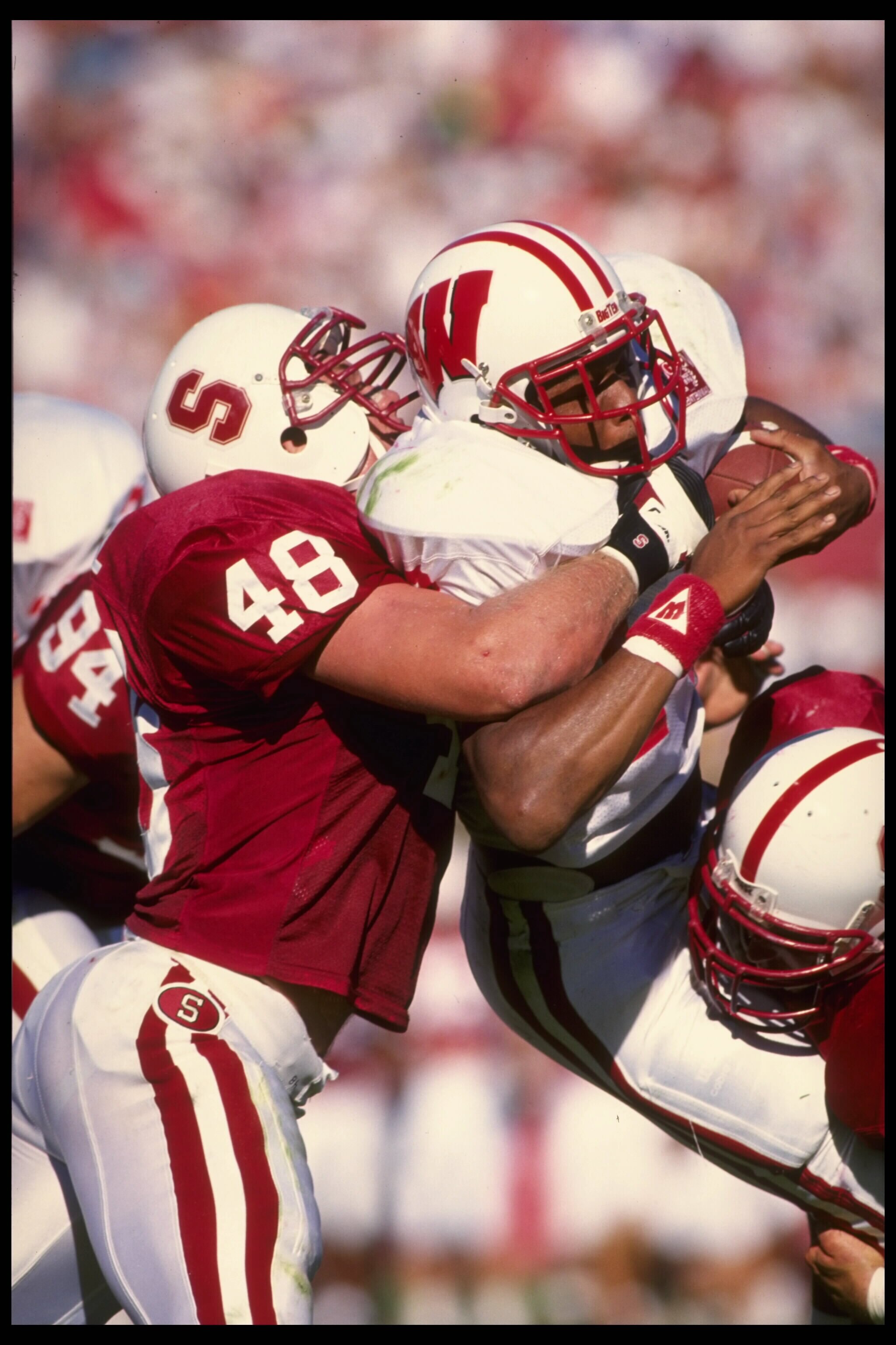 16 SEP 1995:  STANFORD LINEBACKER MIKE HALL #48 TACKLES WISCONSIN RUNNING BACK CARL MCCULLOUGH DURING A 24-24 TIE AT STANFORD STADIUM IN STANFORD, CALIFORNIA.  MANDATORY CREDIT:  OTTO GREULE/ALLSPORT