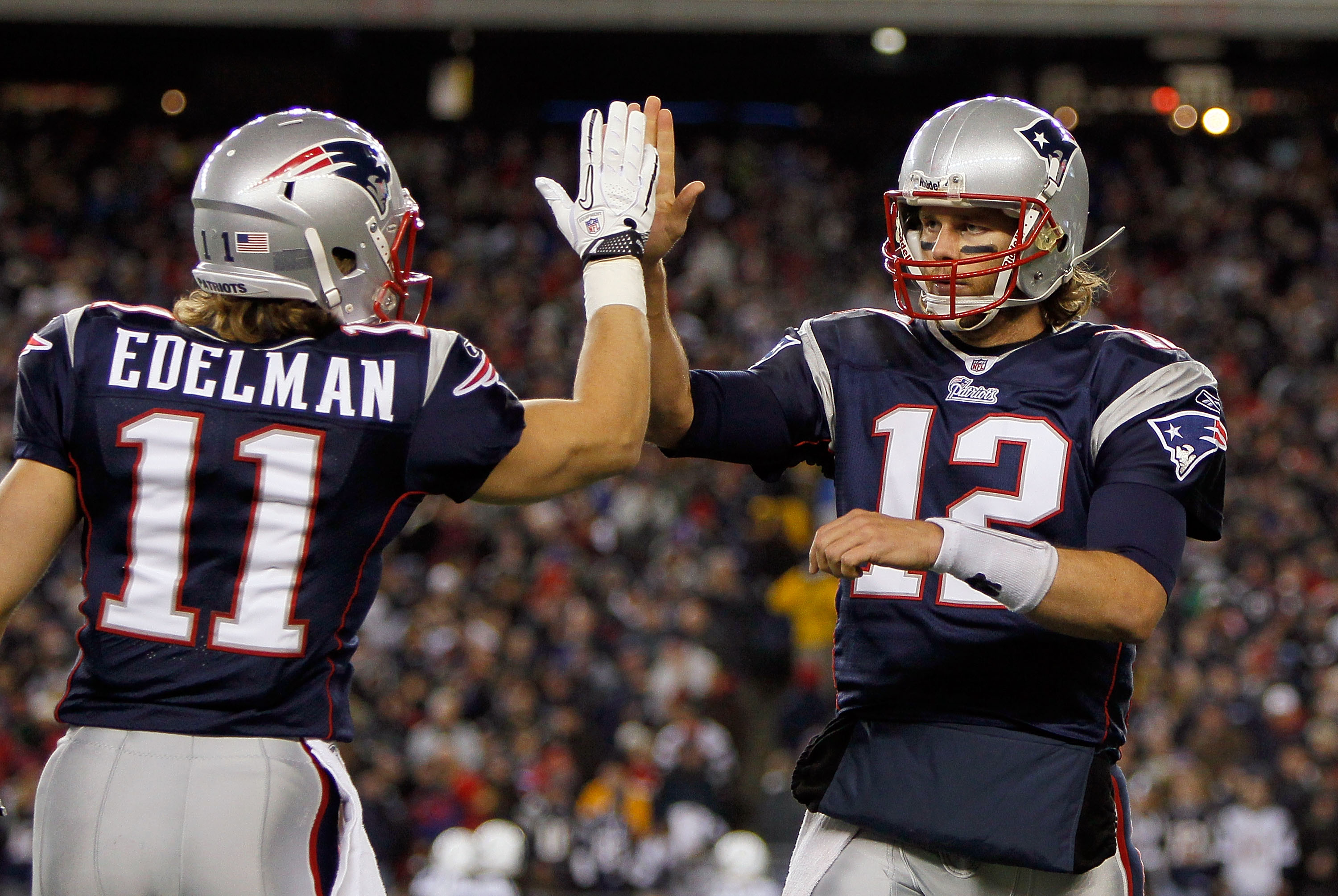 FOXBORO, MA - NOVEMBER 21: Tom Brady #12 of the New England Patriots reacts with teammate Julian Edelman #11 after a touchdown in the second half at Gillette Stadium on November 21, 2010 in Foxboro, Massachusetts. (Photo by Jim Rogash/Getty Images)