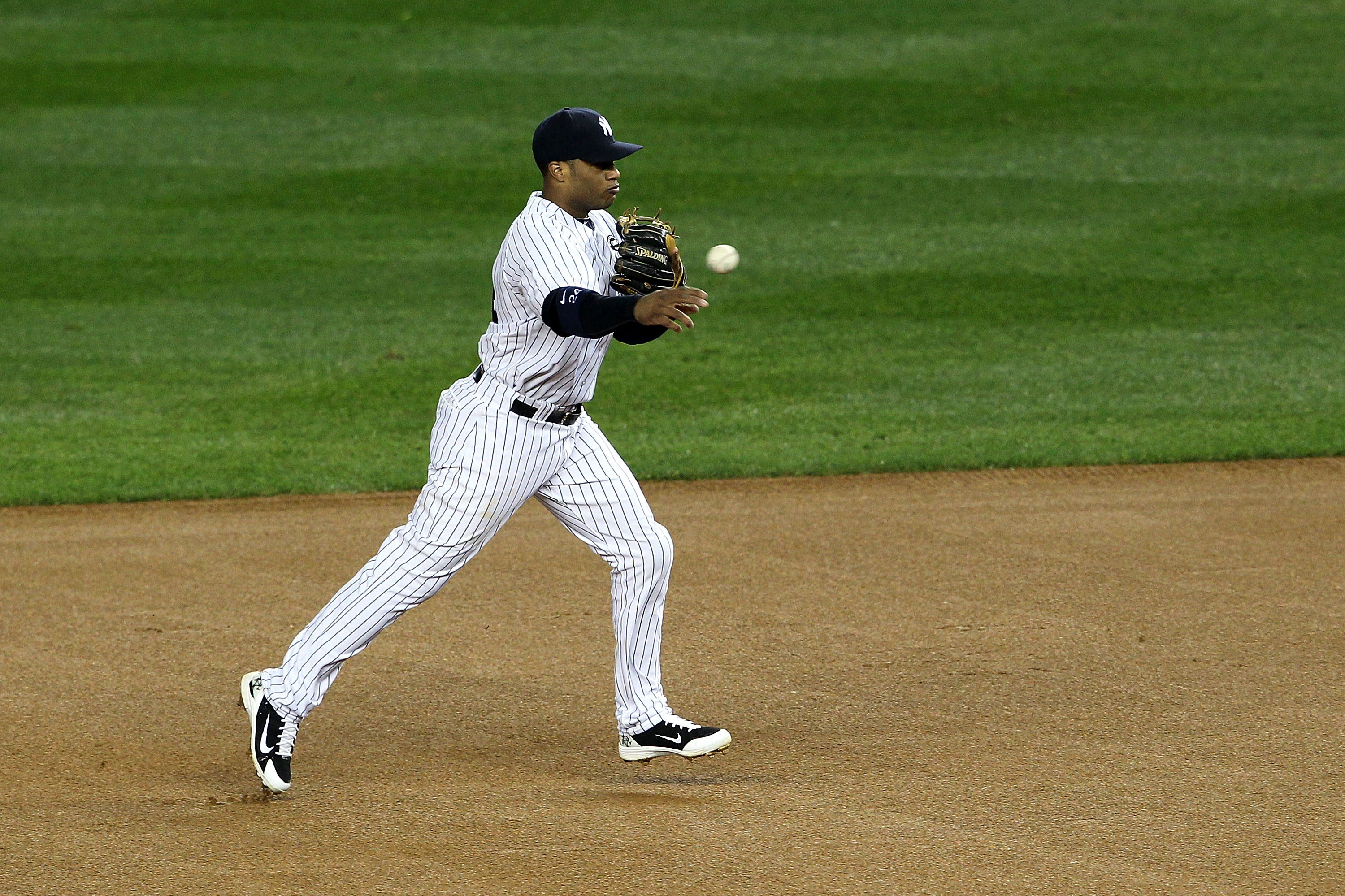 NEW YORK - OCTOBER 19:  Robinson Cano #24 of the New York Yankees throws the ball to first base against the Texas Rangers in Game Four of the ALCS during the 2010 MLB Playoffs at Yankee Stadium on October 19, 2010 in the Bronx borough of New York City.  (