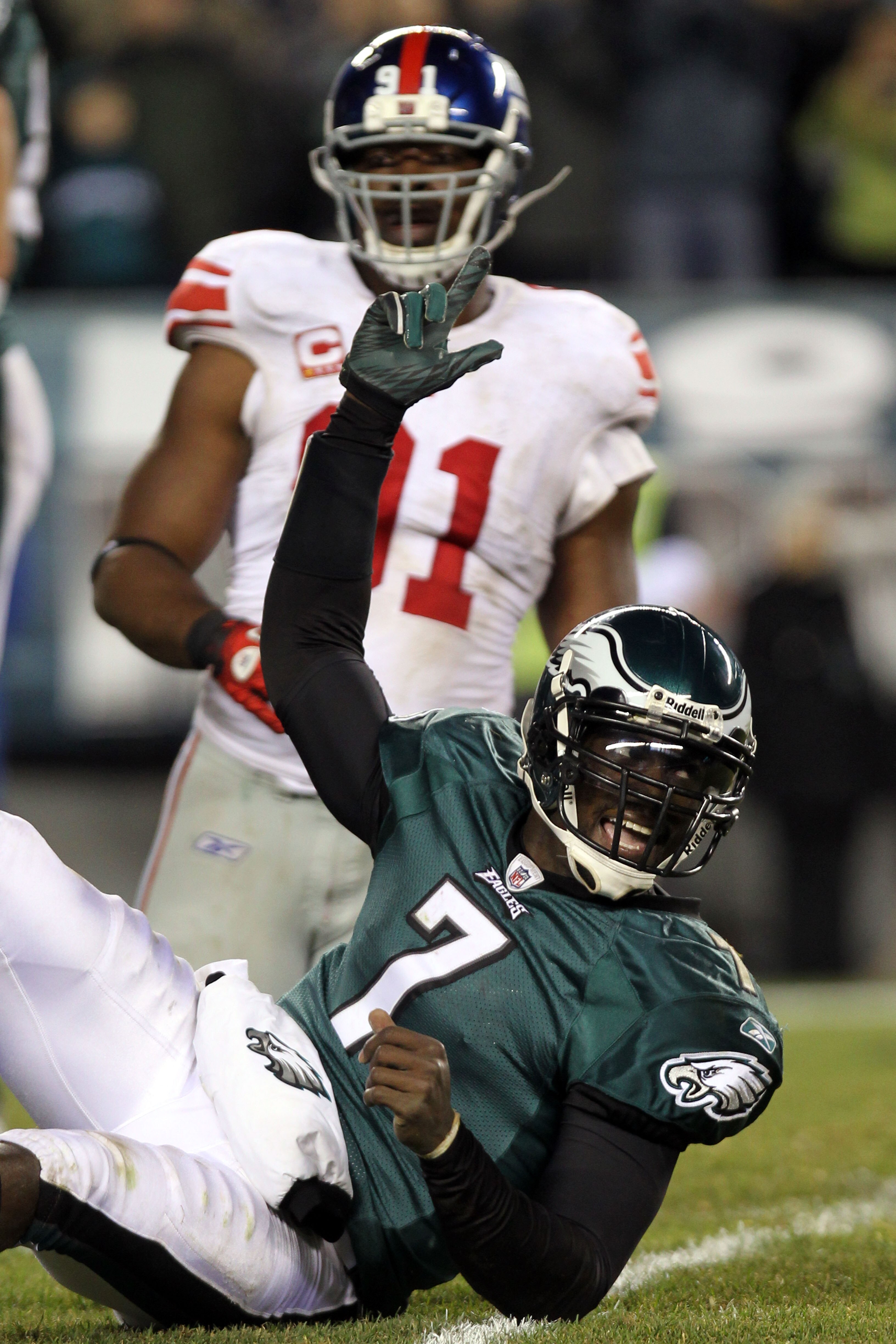 PHILADELPHIA - NOVEMBER 21:  Michael Vick #7 of the Philadelphia Eagles celebrates after throwing converting on a two point conversion in the fourth quarter as Justin Tuck #91 of the New York Giants looks on at Lincoln Financial Field on November 21, 2010