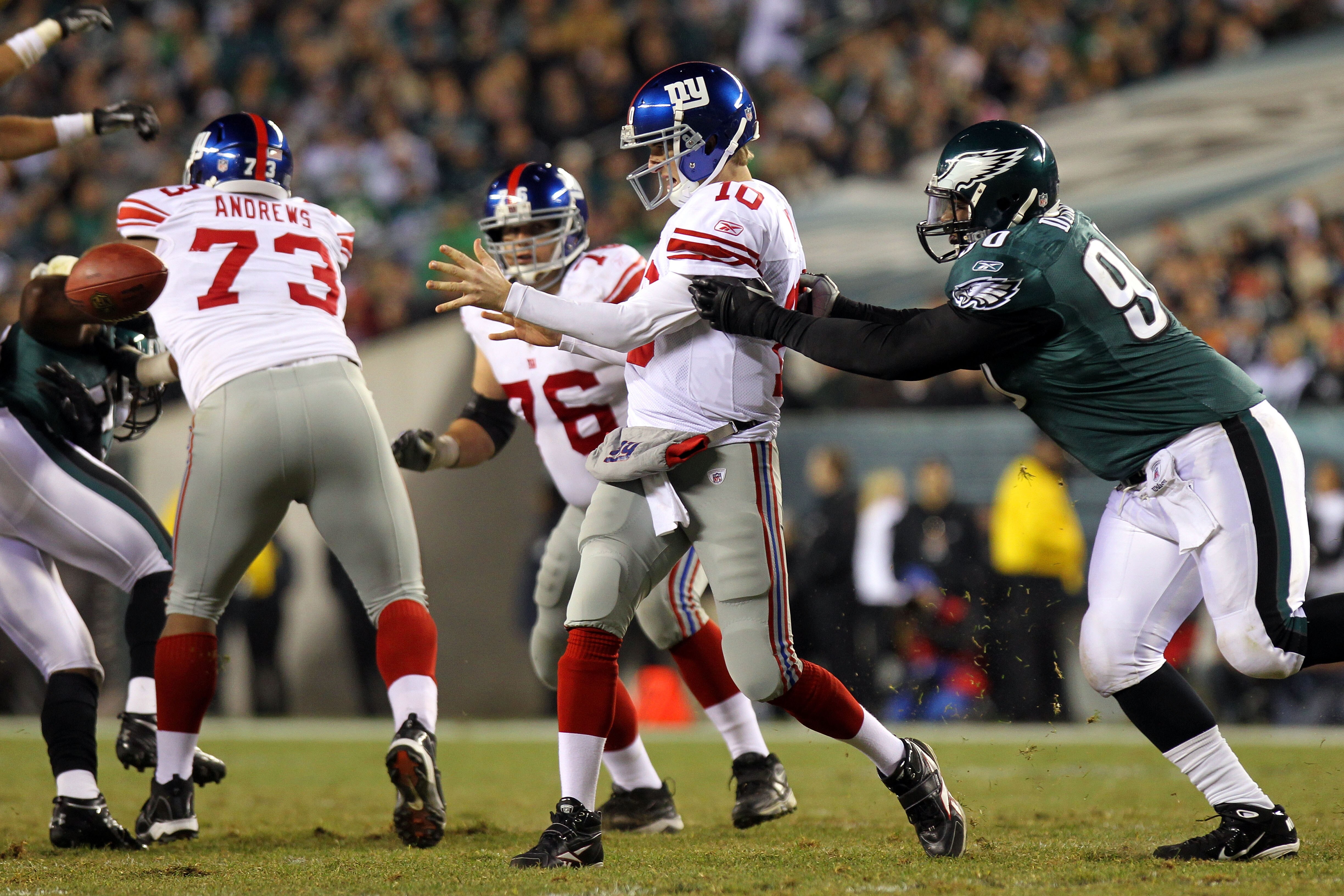 PHILADELPHIA - NOVEMBER 21:  Eli Manning #10 of the New York Giants gets rid of the ball as he is pressured by Antonio Dixon #90 of the Philadelphia Eagles at Lincoln Financial Field on November 21, 2010 in Philadelphia, Pennsylvania.  (Photo by Nick Laha