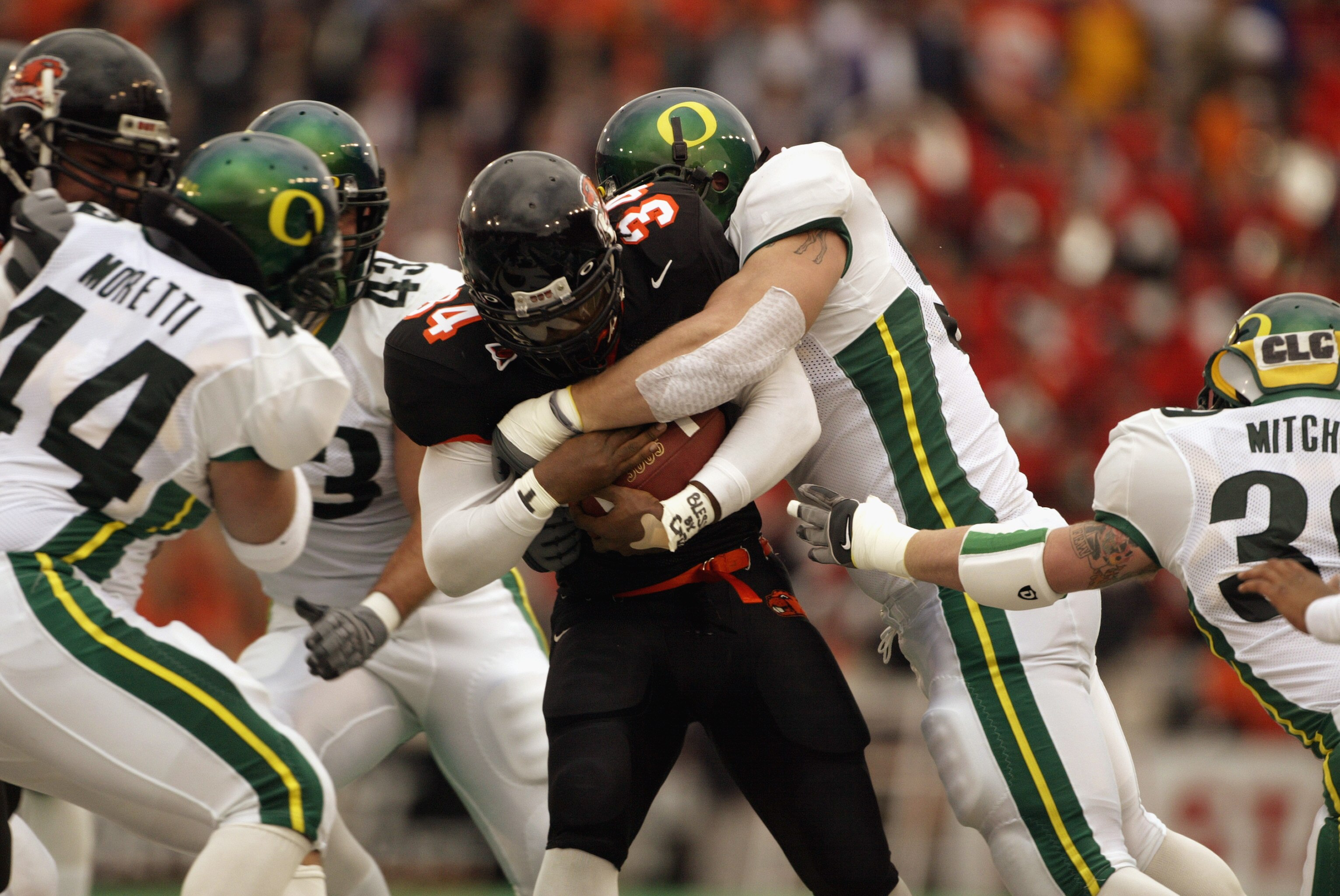 CORVALIS, OR - NOVEMBER 23:  Shawn Jackson #34 of the Oregon State University Beavers is tackled by the University of Oregon Ducks during the 'Civil War' game at Reser Stadium on November 23, 2003 in Corvalis, Oregon. Oregon State won 45-24.  (Photo by Jo