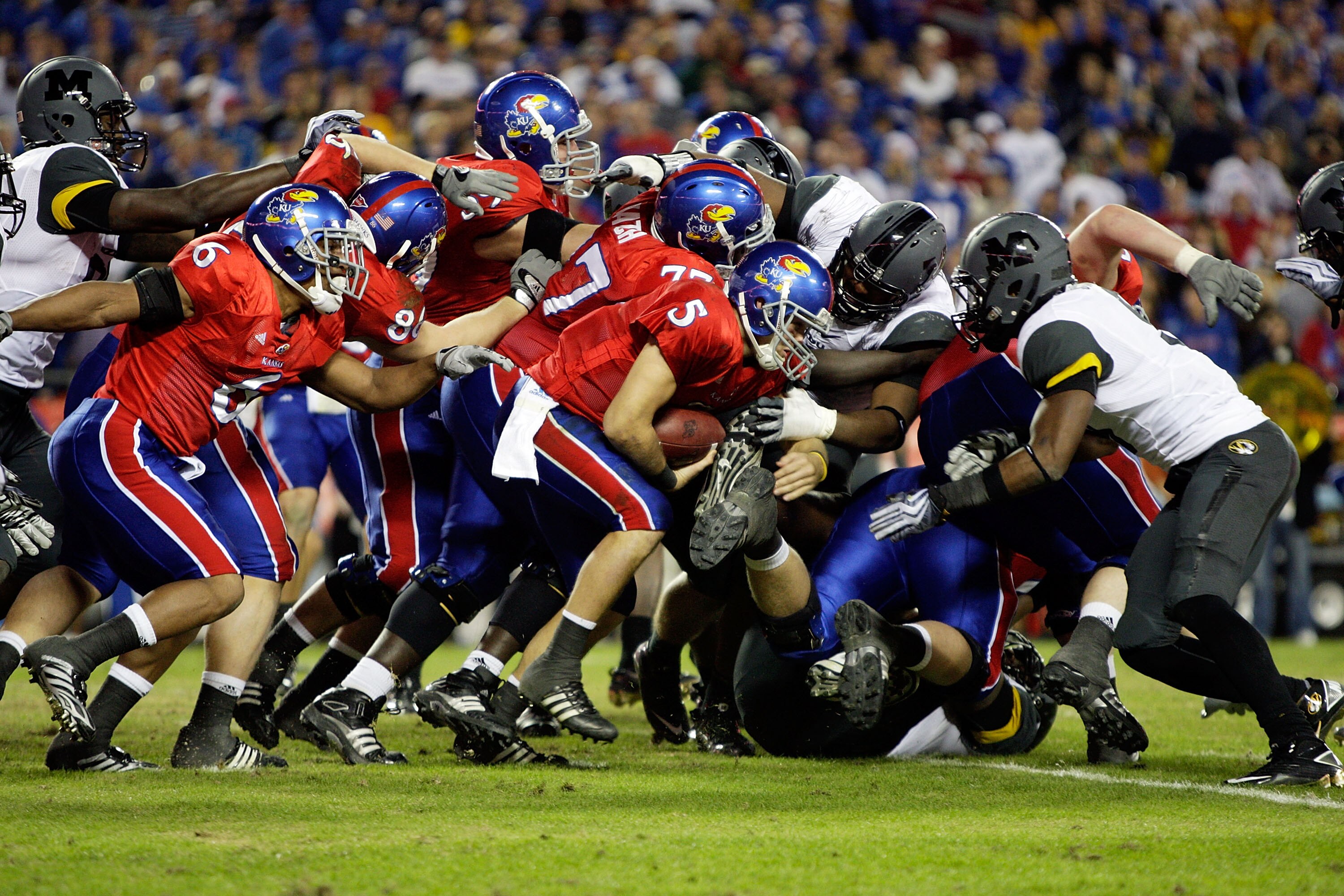 KANSAS CITY, MO - NOVEMBER 28:  Quarterback Todd Reesing #5 of the Kansas Jayhawks carries the ball on a keeper during the game against the Missouri Tigers at Arrowhead Stadium on November 28, 2009 in Kansas City, Missouri.  (Photo by Jamie Squire/Getty I