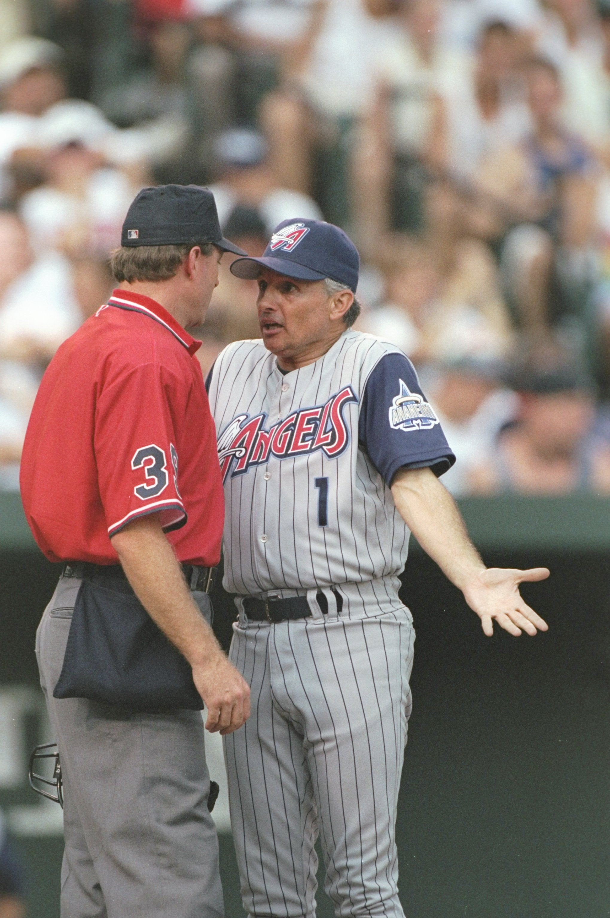 17 Aug 1997:  Manager Terry Collins of the Anaheim Angels argues with umpire Ed Hickox during a game against the Baltimore Orioles at Camden Yards in Baltimore, Maryland.  The Orioles won the game, 5-4. Mandatory Credit: Doug Pensinger  /Allsport