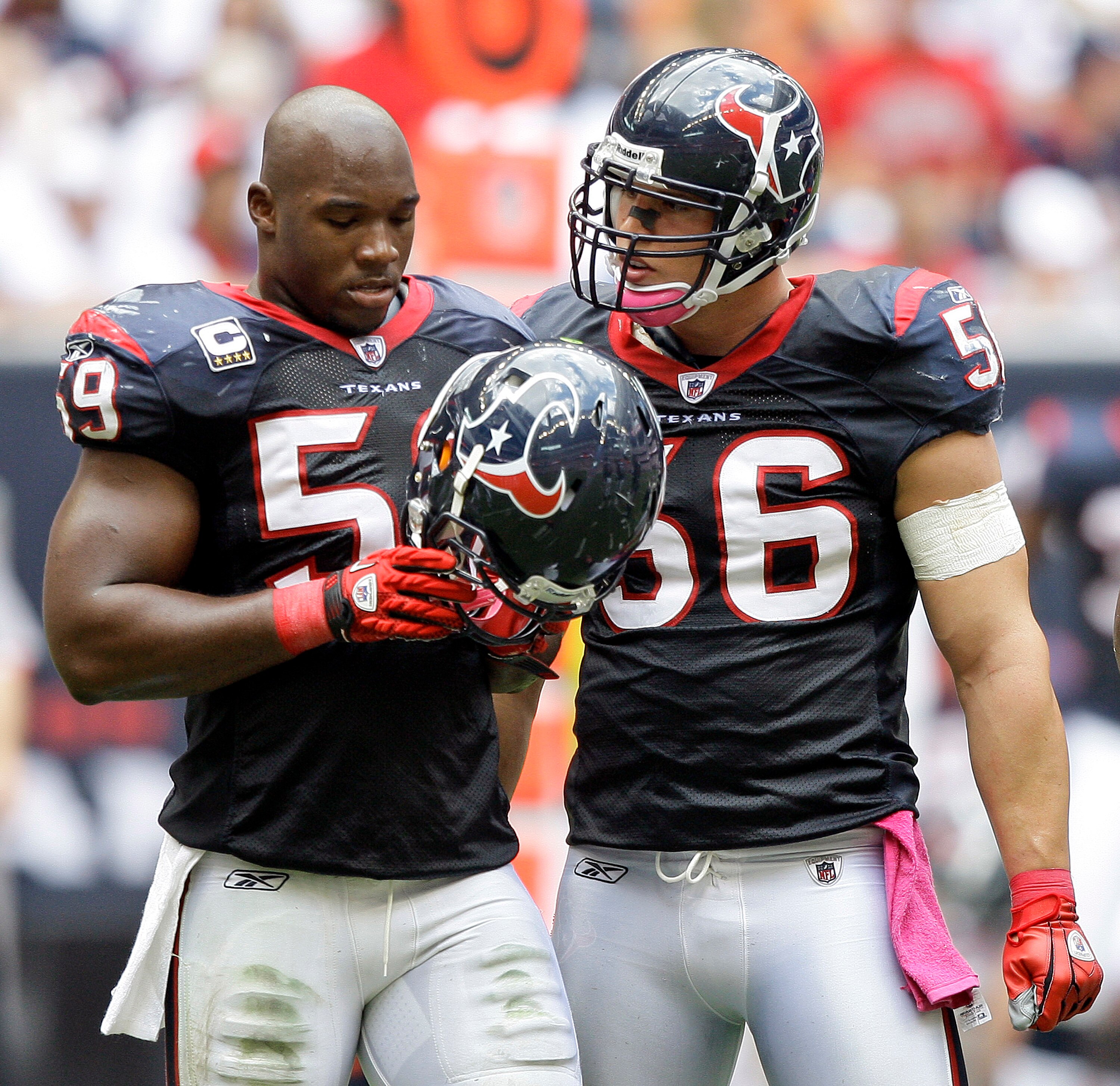 HOUSTON - OCTOBER 17:  DeMeco Ryans #59 and Brian Cushing #56 of the Houston Texans talk during a break in the play during  a game against the Kansas City Chiefs at Reliant Stadium on October 17, 2010 in Houston, Texas.  (Photo by Bob Levey/Getty Images)