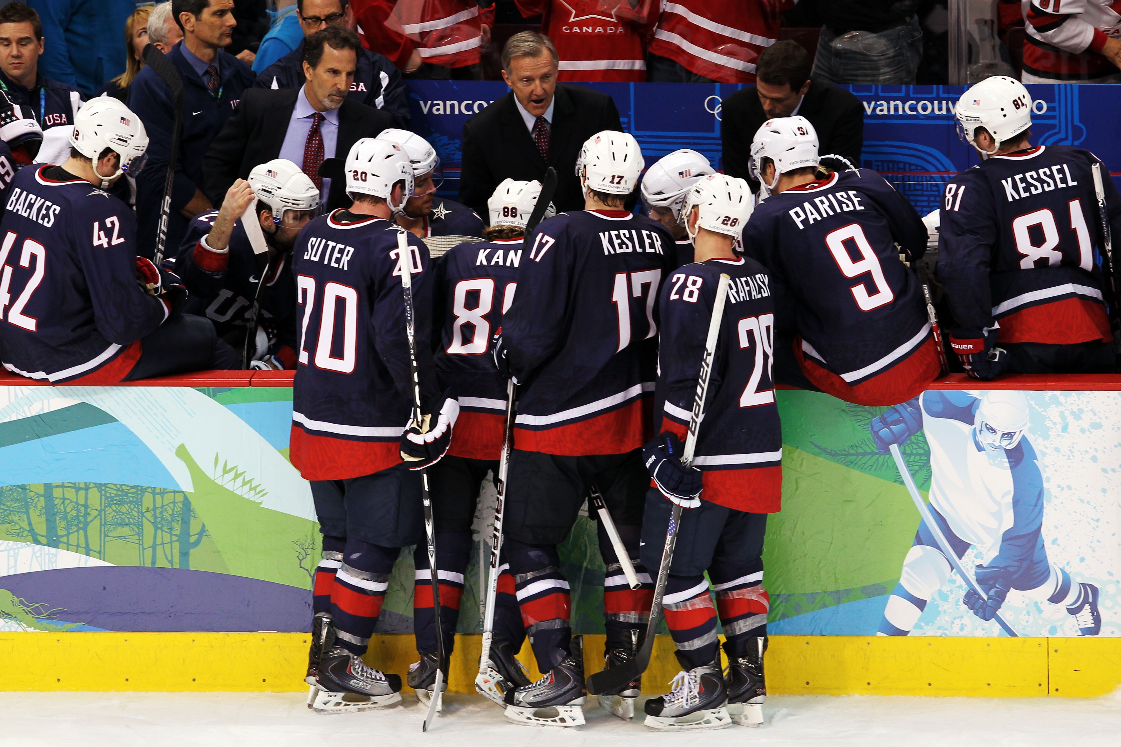 VANCOUVER, BC - FEBRUARY 28:  Team USA players listen to Coach Ron Wilson after a time out is called during the ice hockey men's gold medal game between USA and Canada on day 17 of the Vancouver 2010 Winter Olympics at Canada Hockey Place on February 28,