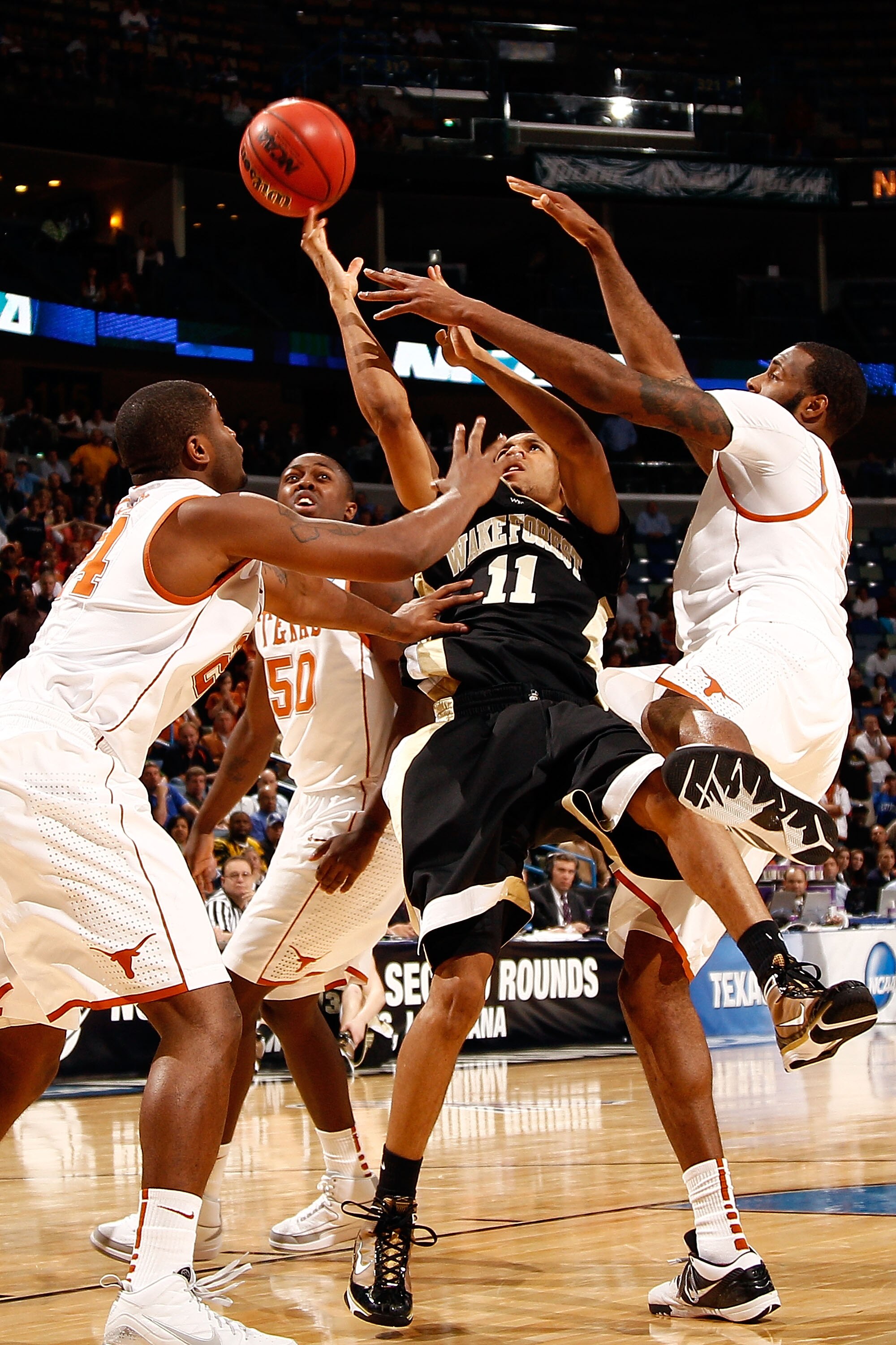 NEW ORLEANS - MARCH 18:  C.J. Harris #11 of the Wake Forest Demon Deacons shoots the ball Justin Mason #24 of the Texas Longhorns during the first round of the 2010 NCAA menï¿½s basketball tournament at the New Orleans Arena on March 18, 2010 in New Orleans