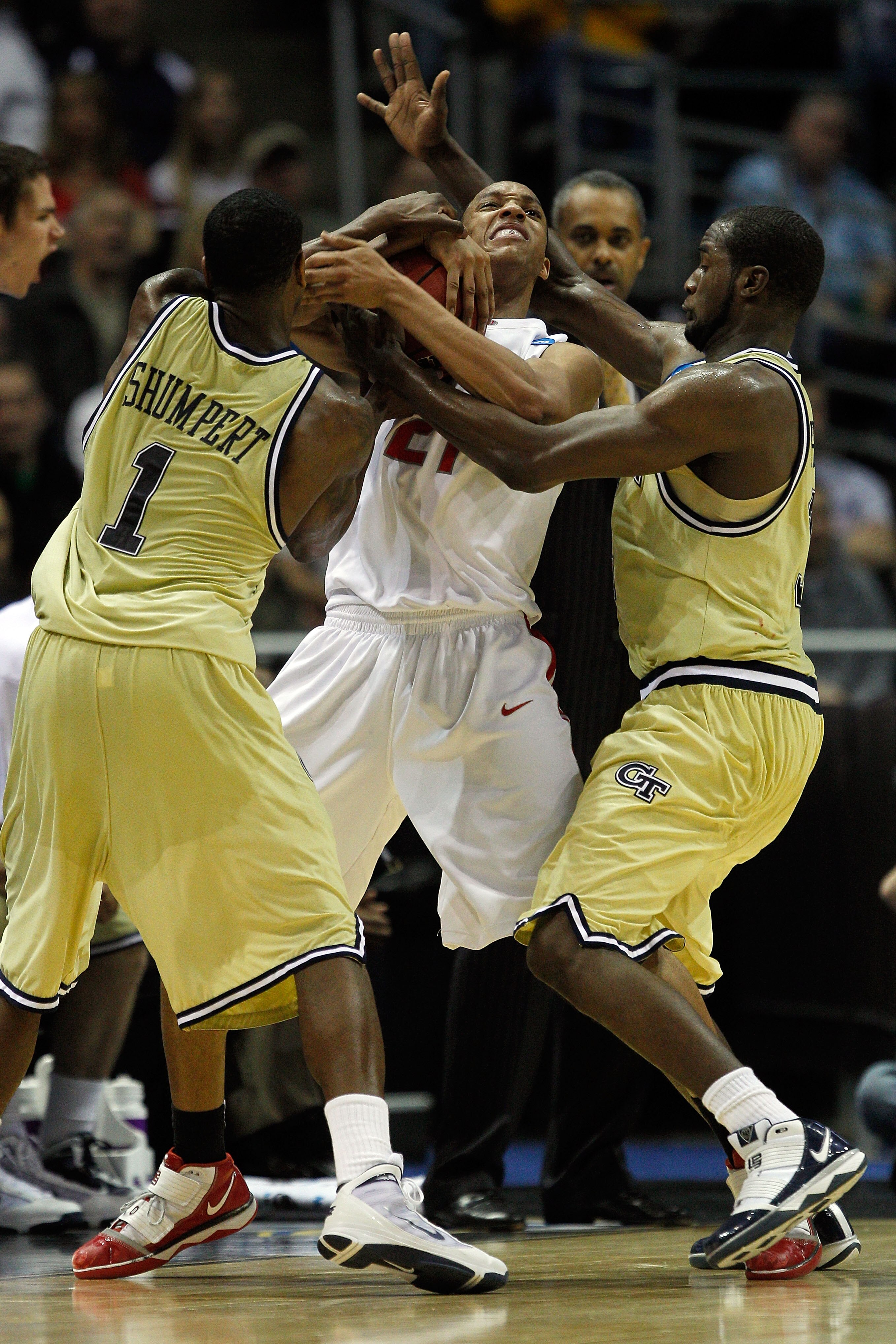 MILWAUKEE - MARCH 21:  Evan Turner #21 of the Ohio State Buckeyes is double-teammed by Iman Shumpert #1 and Zachery Peacock #35 of the Georgia Tech Yellow Jackets in the second half during the second round of the 2010 NCAA men's basketball tournament at t