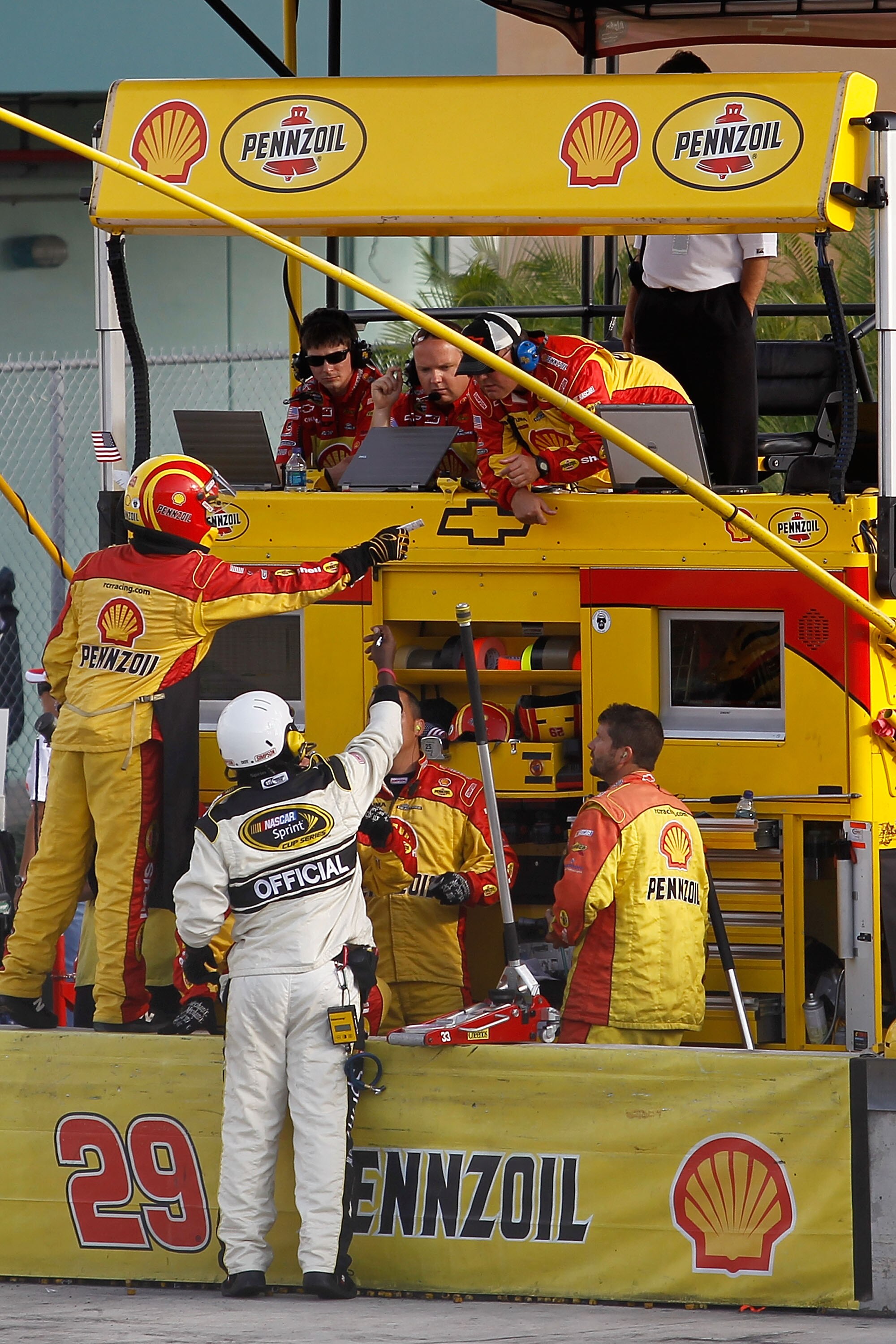 HOMESTEAD, FL - NOVEMBER 21:  Gil Martin (Top R), crew chief for Kevin Harvick, driver of the #29 Shell/Pennzoil Chevrolet, receives a pit road speeding penalty during the NASCAR Sprint Cup Series Ford 400 at Homestead-Miami Speedway on November 21, 2010
