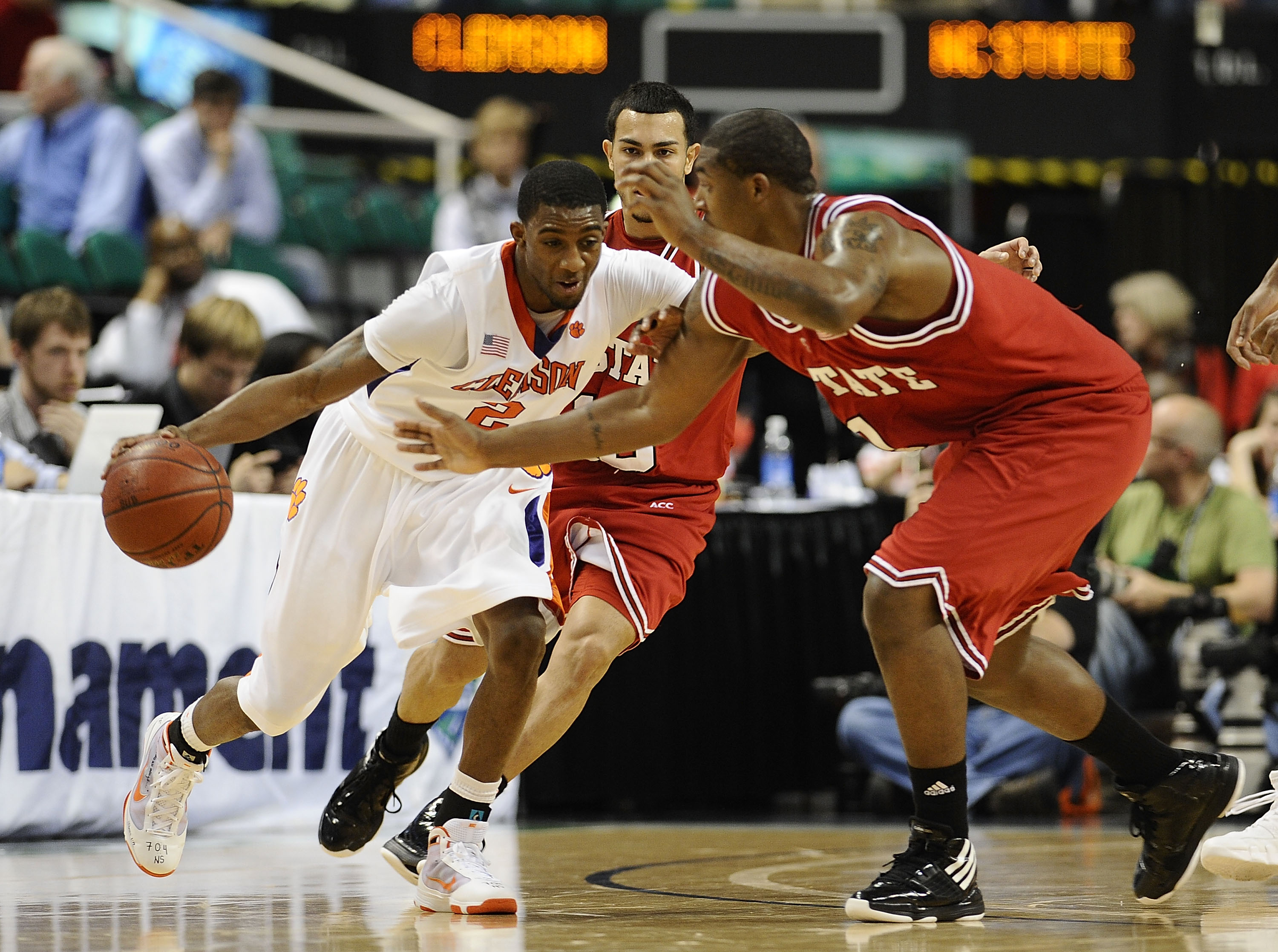 GREENSBORO, NC - MARCH 11:  Demontez Stitt #2 of the Clemson Tigers drives through Javier Gonzalez #10 and Richard Howell #1  of the NC State Wolfpack in their first round game in the 2010 ACC Men's Basketball Tournament at the Greensboro Coliseum on Marc