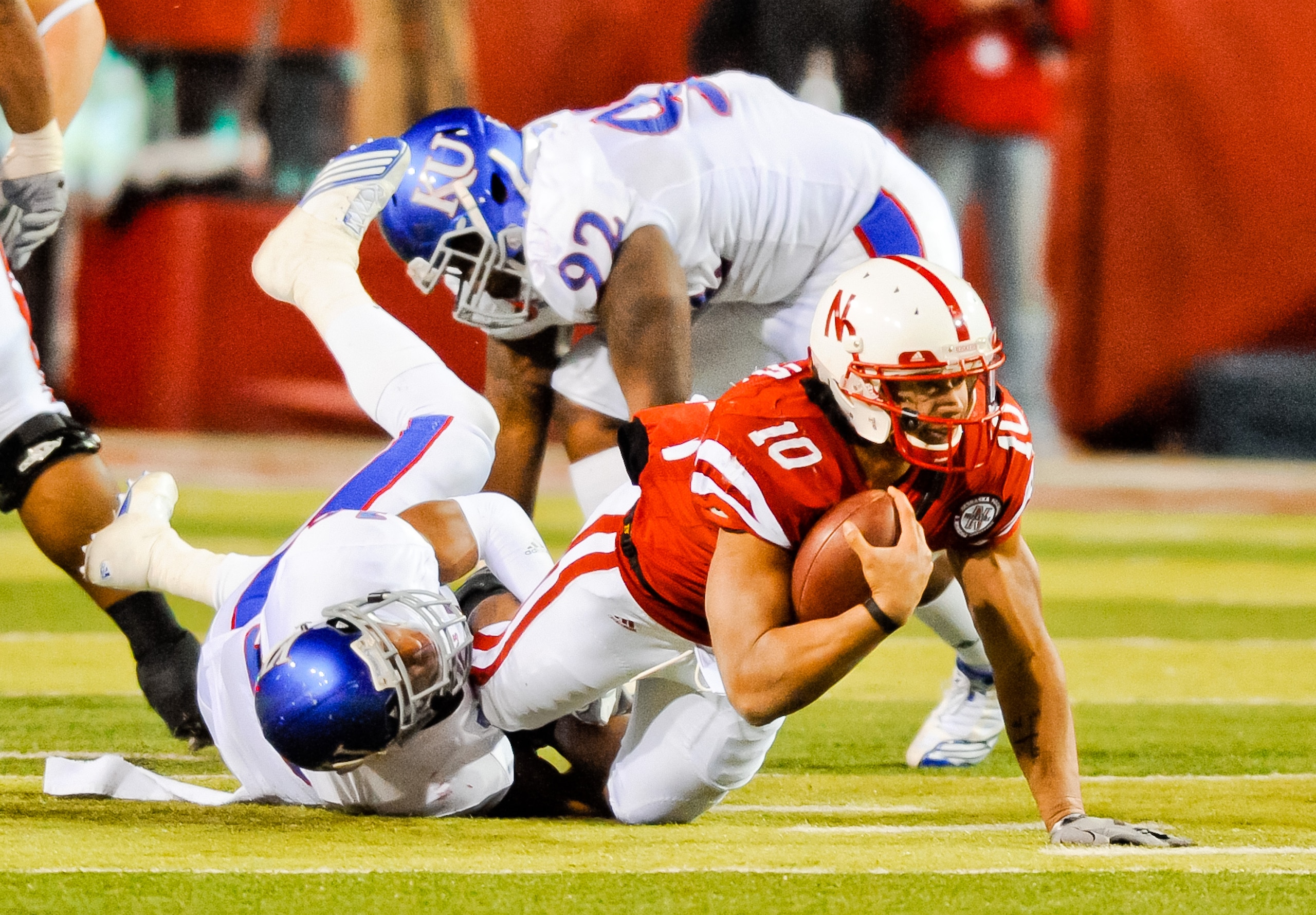 LINCOLN, NE - NOVEMBER 13: Roy Helu Jr. #10 of the Nebraska Cornhuskers is brought down by Isiah Barfield #19 of the Kansas Jayhawks during their game at Memorial Stadium on November 13, 2010 in Lincoln, Nebraska. Nebraska Defeated Kansas 20-3. (Photo by LINCOLN, NE - NOVEMBER 13: Roy Helu Jr. #10 of the Nebraska Cornhuskers is brought down by Isiah Barfield #19 of the Kansas Jayhawks during their game at Memorial Stadium on November 13, 2010 in Lincoln, Nebraska. Nebraska Defeated Kansas 20-3. (Photo by