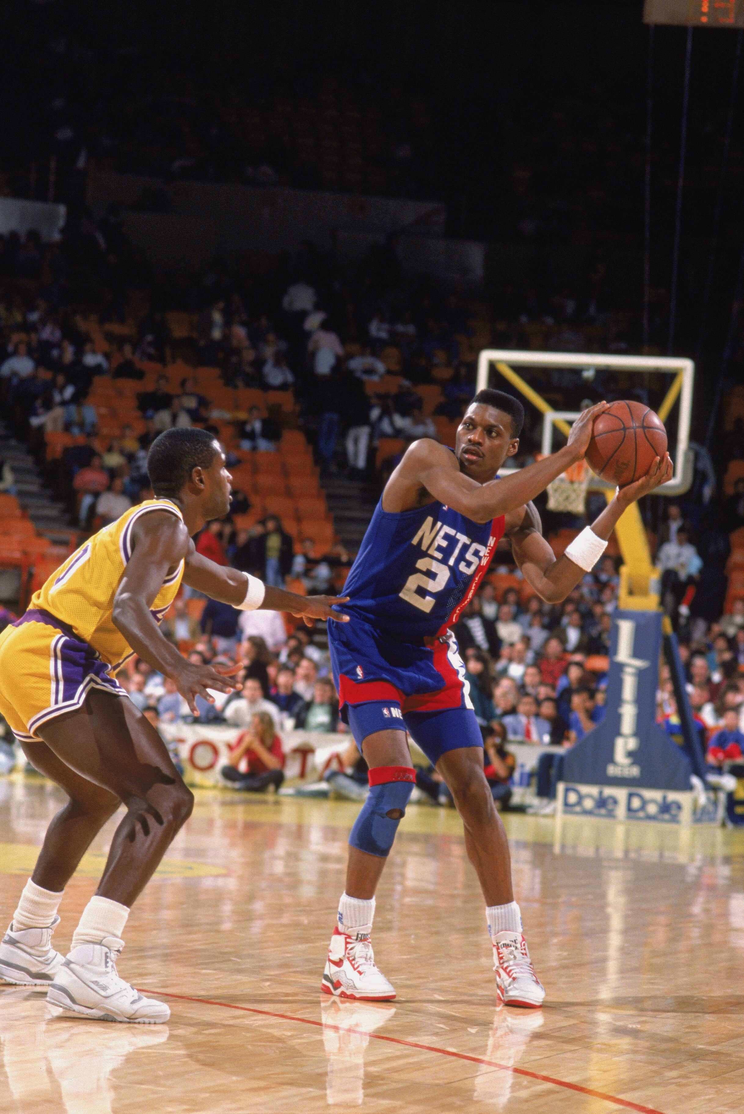 LOS ANGELES - 1990:  Dennis Hopson #2 of the New Jersey Nets holds the ball at the perimeter against defender Larry Drew #10 of the Los Angeles Lakers during the NBA game at the Great Western Forum in Los Angeles, California in 1990. NOTE TO USER: User ex