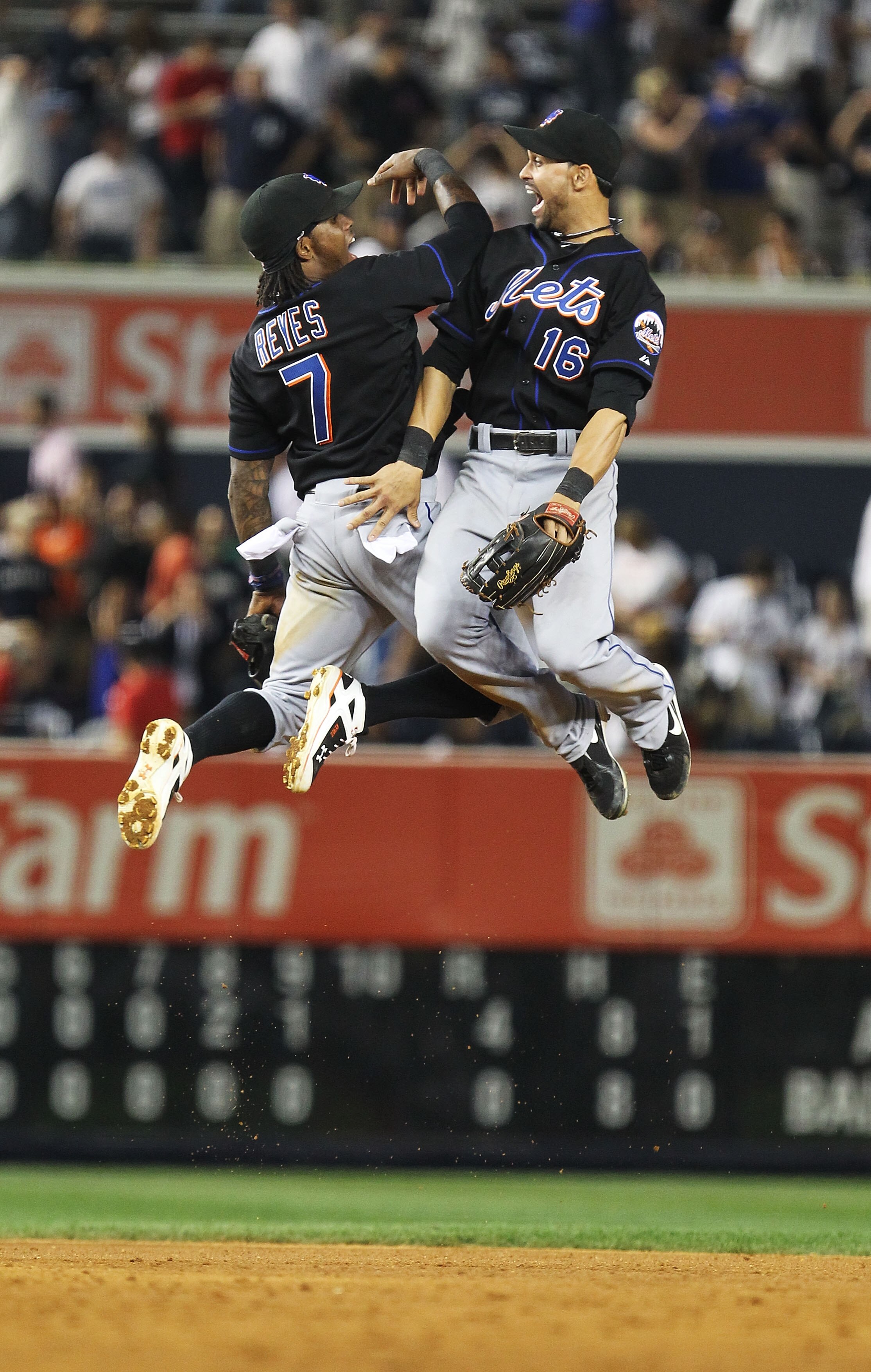 NEW YORK - JUNE 18:  Jose Reyes #7 and Angel Pagan #16 of the New York Mets celebrate a 4-0 win against the New York Yankees on June 18, 2010 at Yankee Stadium in the Bronx borough of New York City.  (Photo by Al Bello/Getty Images)