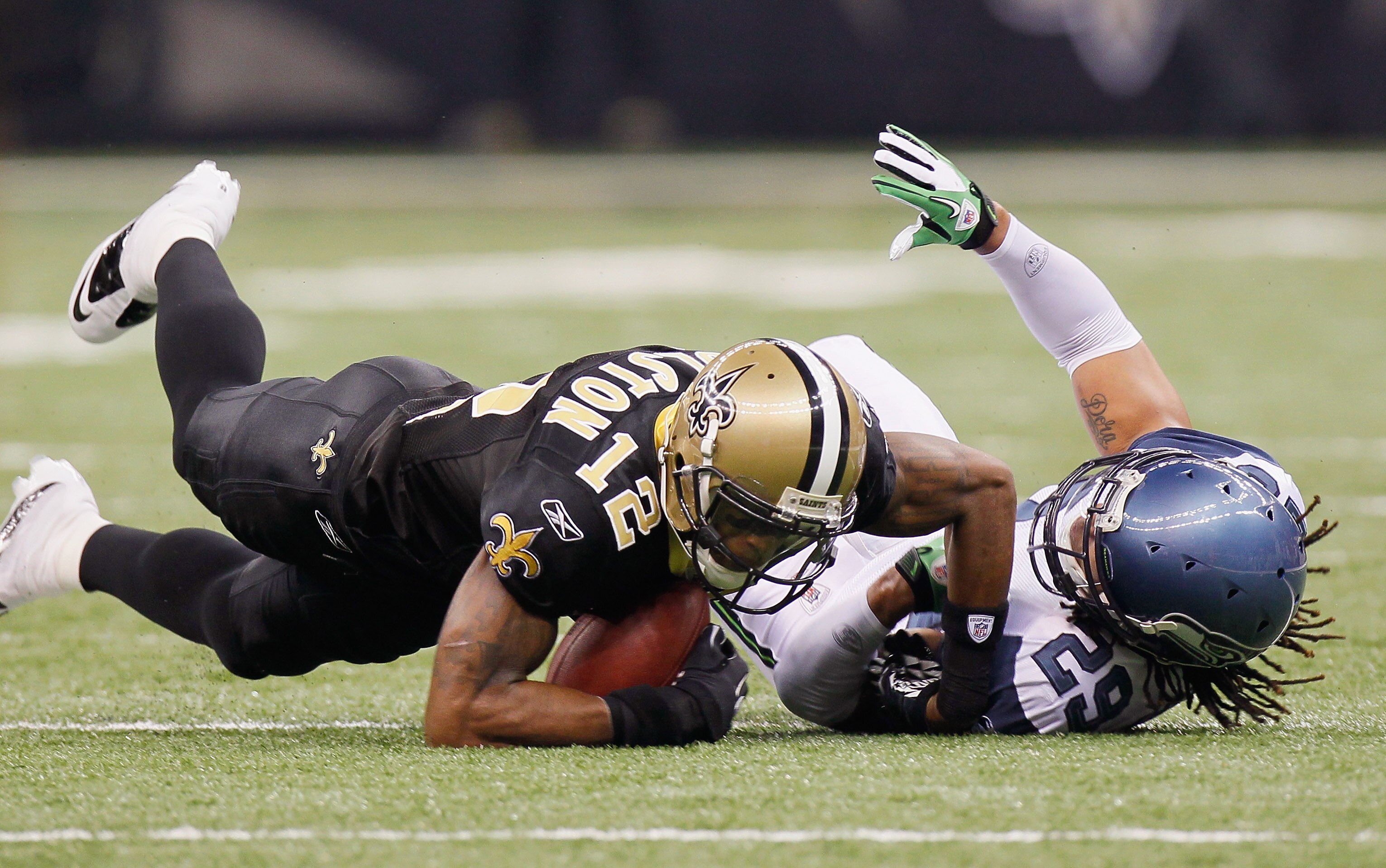 NEW ORLEANS - NOVEMBER 21:  Marques Colston #12 of the New Orleans Saints is tackled by Earl Thomas #29 of the Seattle Seahawks at Louisiana Superdome on November 21, 2010 in New Orleans, Louisiana.  (Photo by Kevin C. Cox/Getty Images)