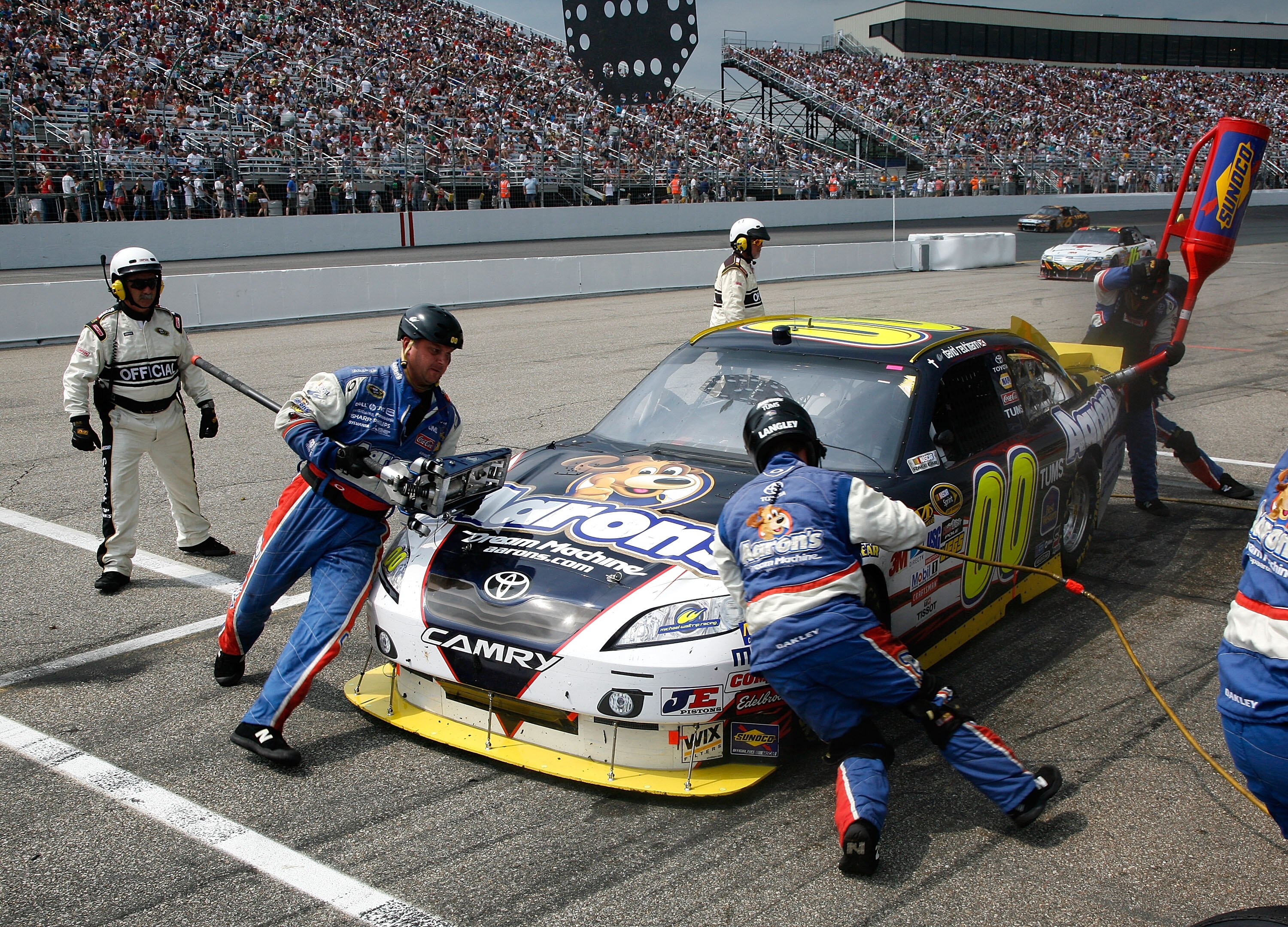 LOUDON, NH - JUNE 27:  David Reutimann, driver of the #00 Aaron's Dream Machine Toyota, makes pit stop during the NASCAR Sprint Cup Series LENOX Industrial Tools 301 at New Hampshire Motor Speedway on June 27, 2010 in Loudon, New Hampshire.  (Photo by Jer