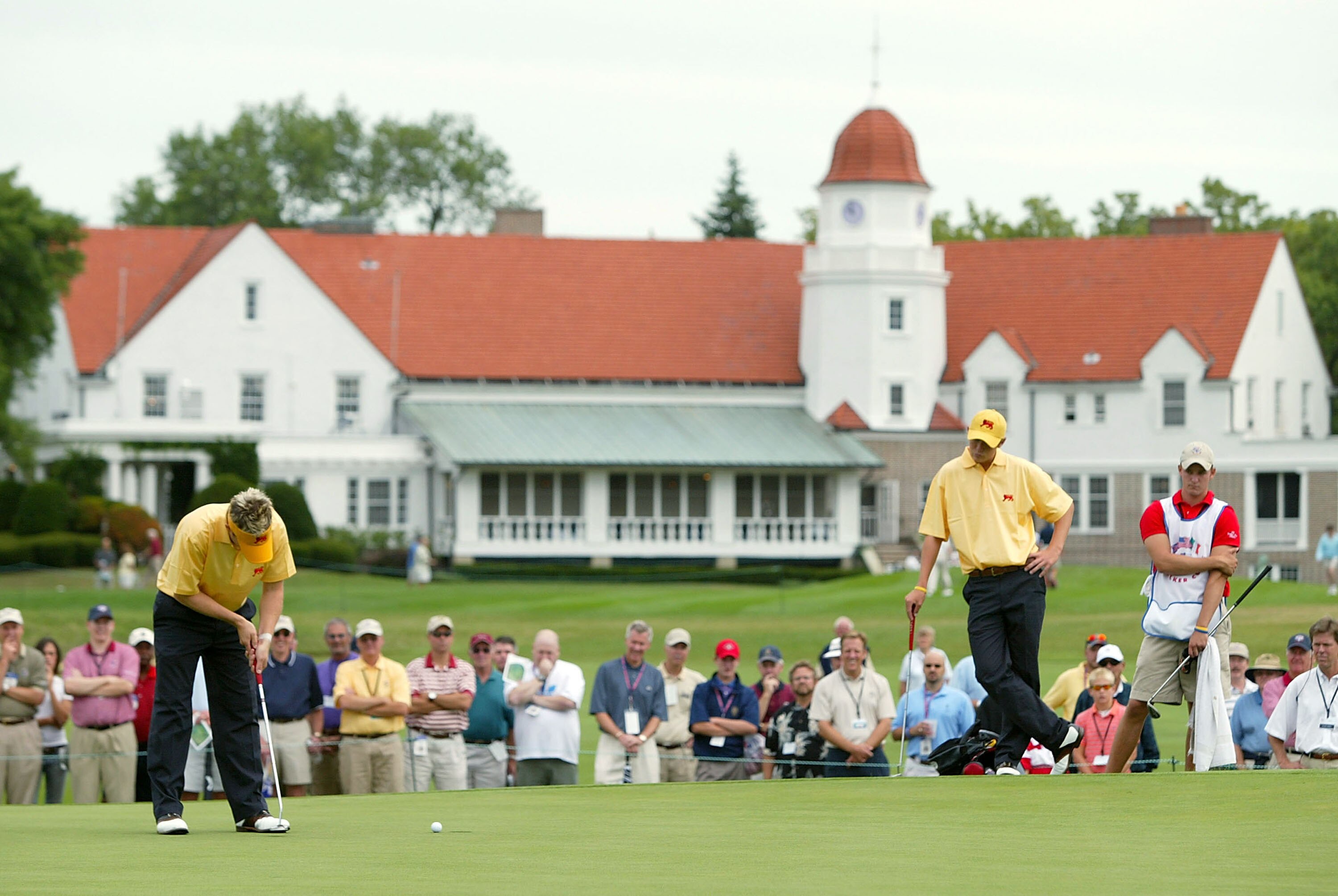 WHEATON, IL - AUGUST 14:  Richie Ramsay of Great Britain and Ireland putts out on the 15th green as partner Lloyd Saltman looks on during the Sunday morning foursomes matches of the 40th Walker Cup August 14, 2005 at Chicago Golf Club in Wheaton, Illinois