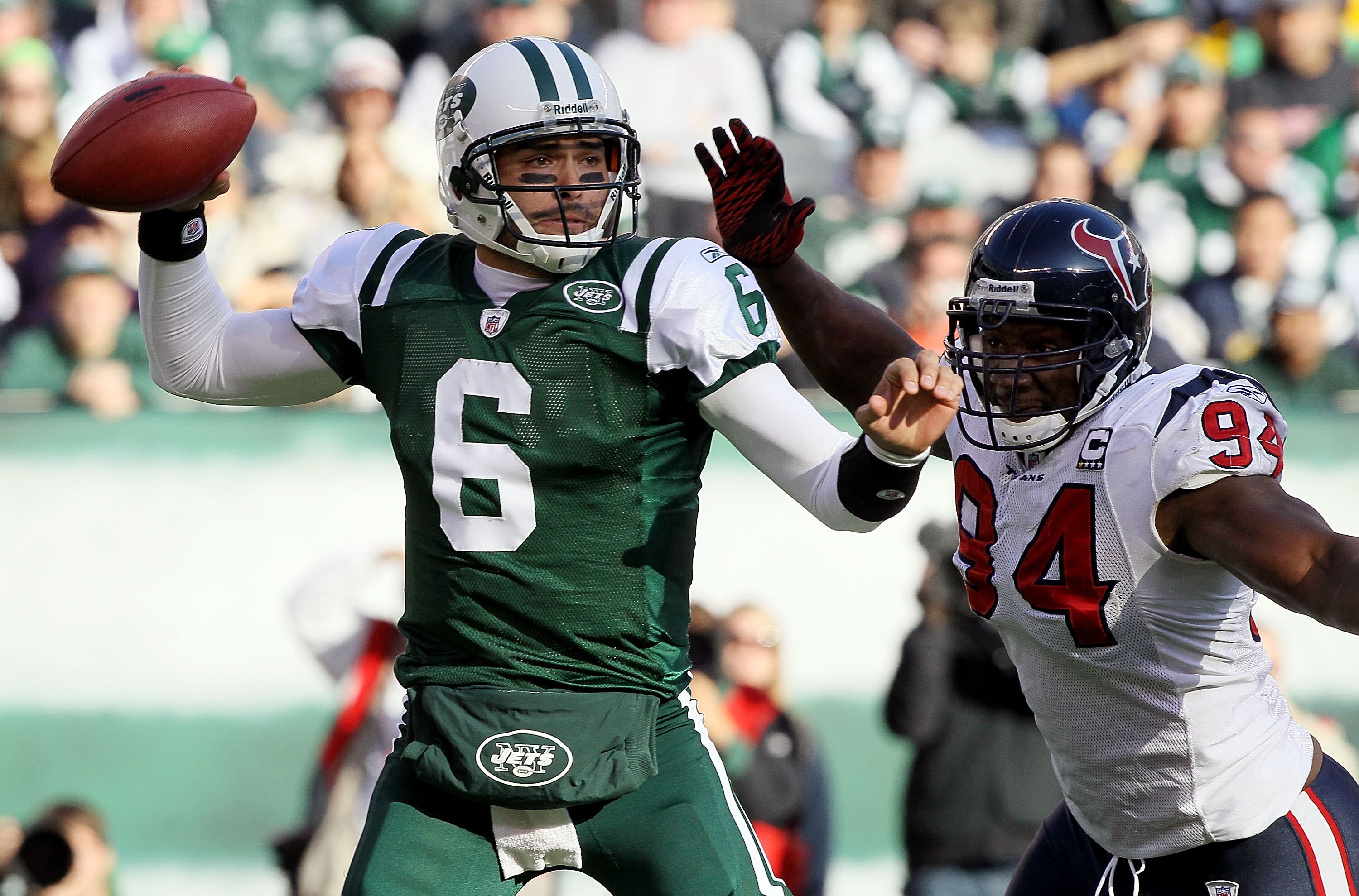 EAST RUTHERFORD, NJ - NOVEMBER 21:  Mark Sanchez #6 of the New York Jets throws a pass under pressure from Antonio Smith #94 of the Houston Texans on November 21, 2010 at the New Meadowlands Stadium in East Rutherford, New Jersey.  (Photo by Jim McIsaac/G