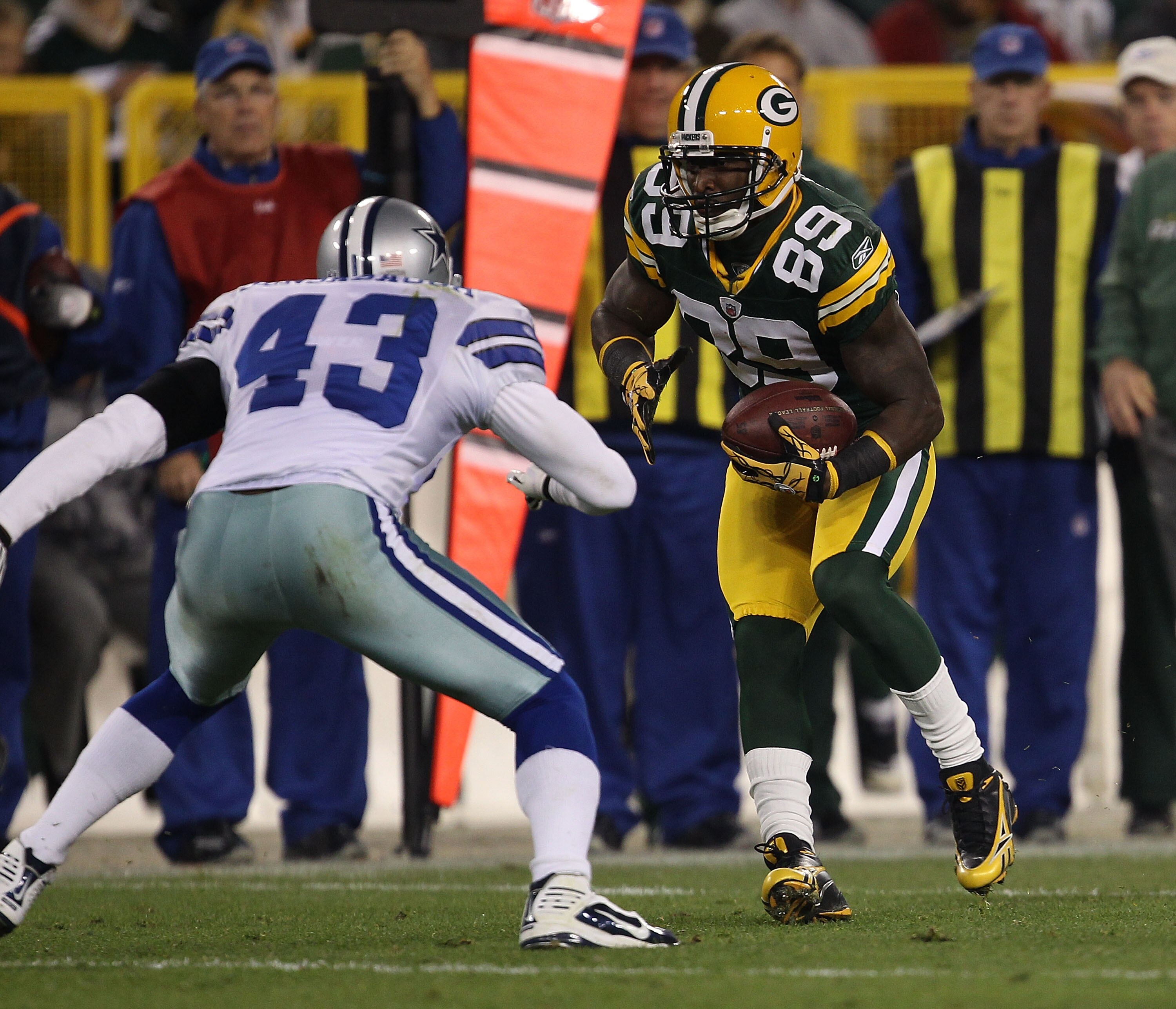GREEN BAY, WI - NOVEMBER 07: James Jones #89 of the Green Bay Packers runs after a catch as Gerald Sensabaugh #43 of the Dallas Cowboys moves in for the tackle attempt at Lambeau Field on November 7, 2010 in Green Bay, Wisconsin. The Packers defeated the