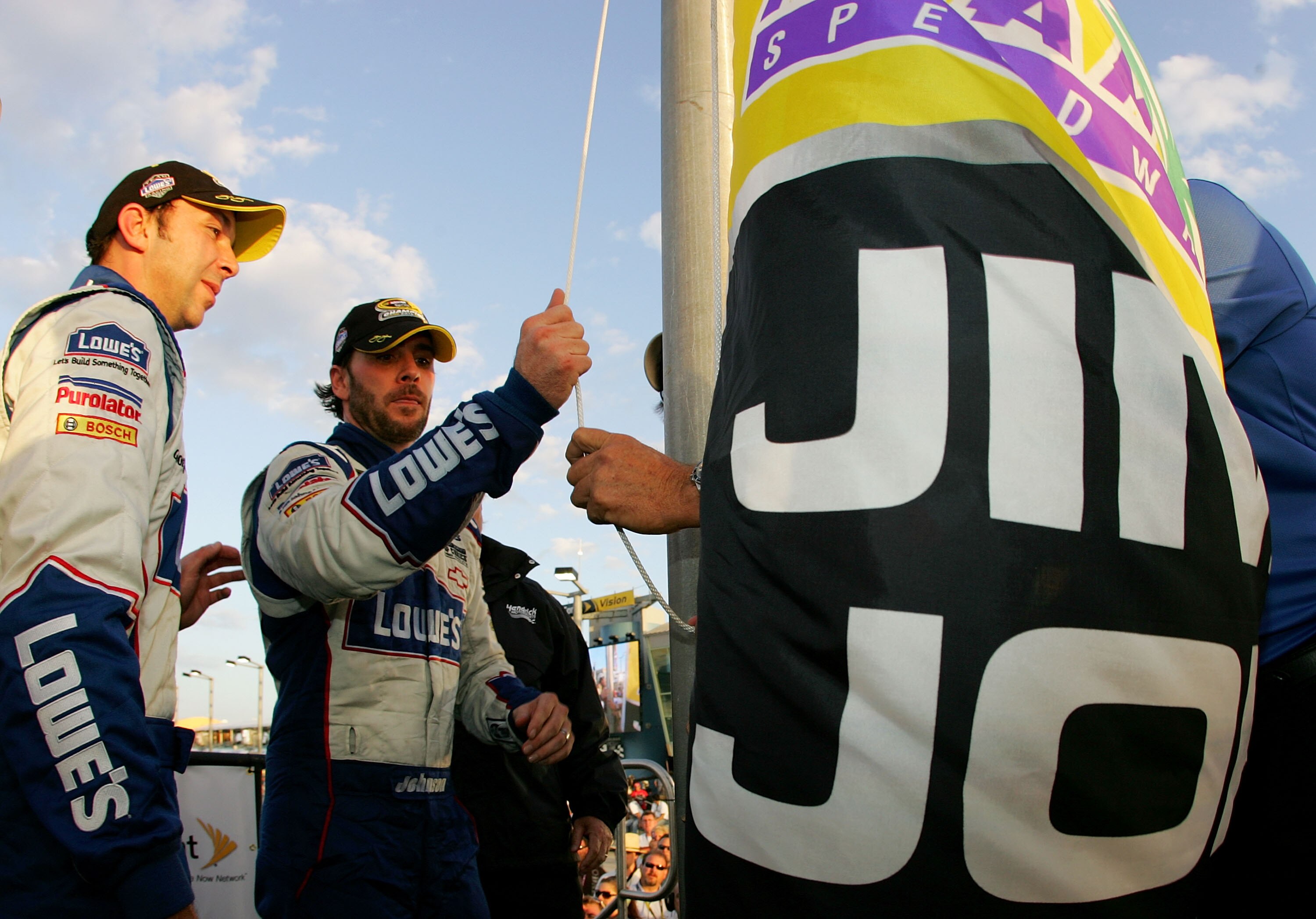HOMESTEAD, FL - NOVEMBER 21:  Jimmie Johnson, driver of the #48 Lowe's Chevrolet raises the Champion's flag after clinching the 2010 NASCAR Championship following the NASCAR Sprint Cup Series Ford 400 at Homestead-Miami Speedway on November 21, 2010 in Ho