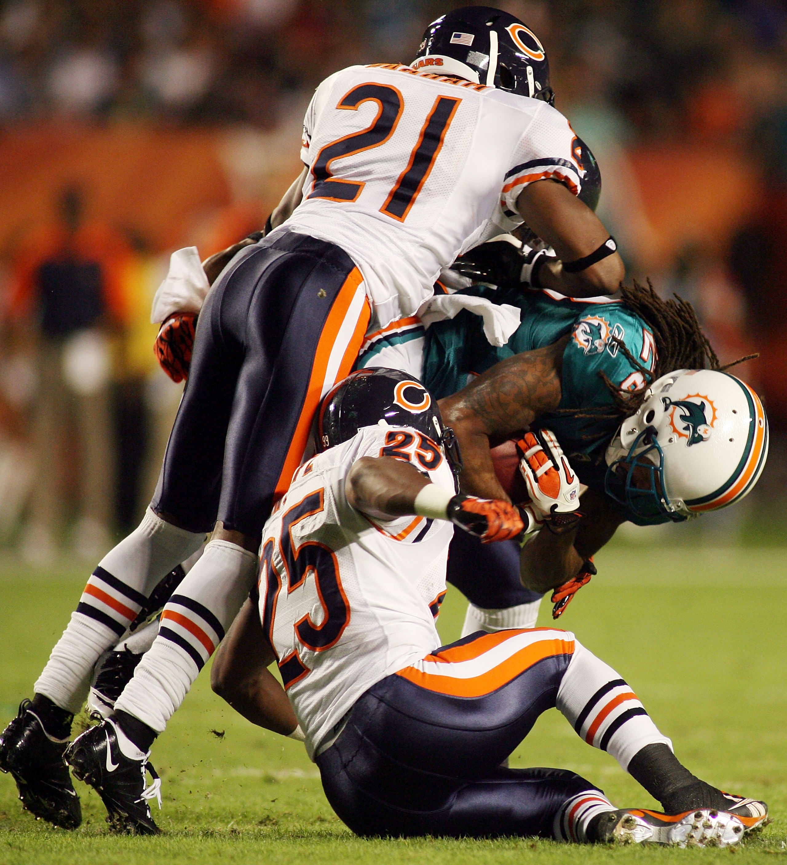 MIAMI - NOVEMBER 18:  Receiver Davone Bess #15 of the Miami Dolphinsis tackled by Corey Graham #21 and Garrett Wolfe #25 of the Chicago Bears at Sun Life Stadium on November 18, 2010 in Miami, Florida.  (Photo by Marc Serota/Getty Images)