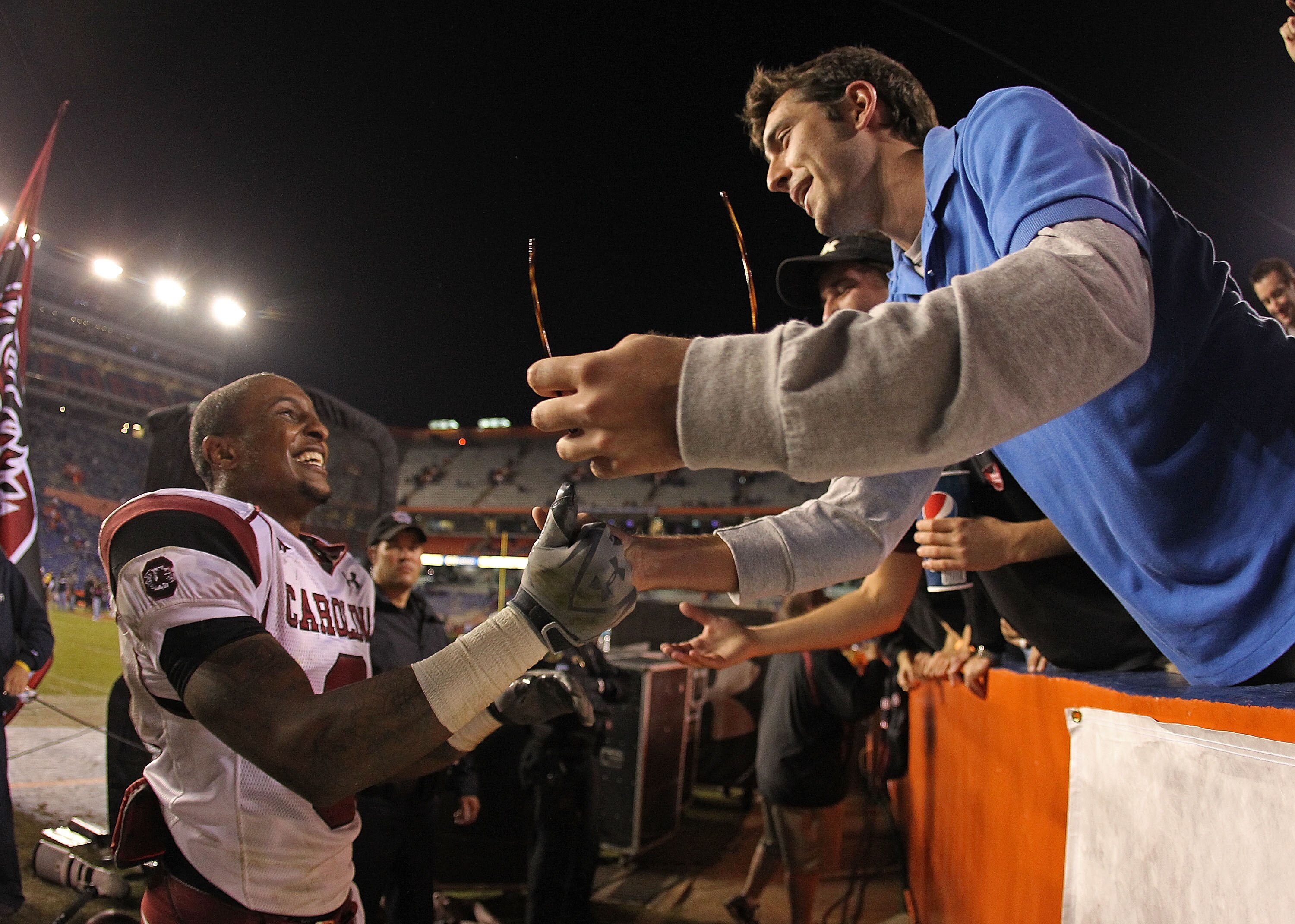 GAINESVILLE, FL - NOVEMBER 13:  Nick Jones #3 of the South Carolina Gamecocks greets a fan after winning a game against the Florida Gators at Ben Hill Griffin Stadium on November 13, 2010 in Gainesville, Florida. The Gamecocks beat the Gators 36-14.  (Pho